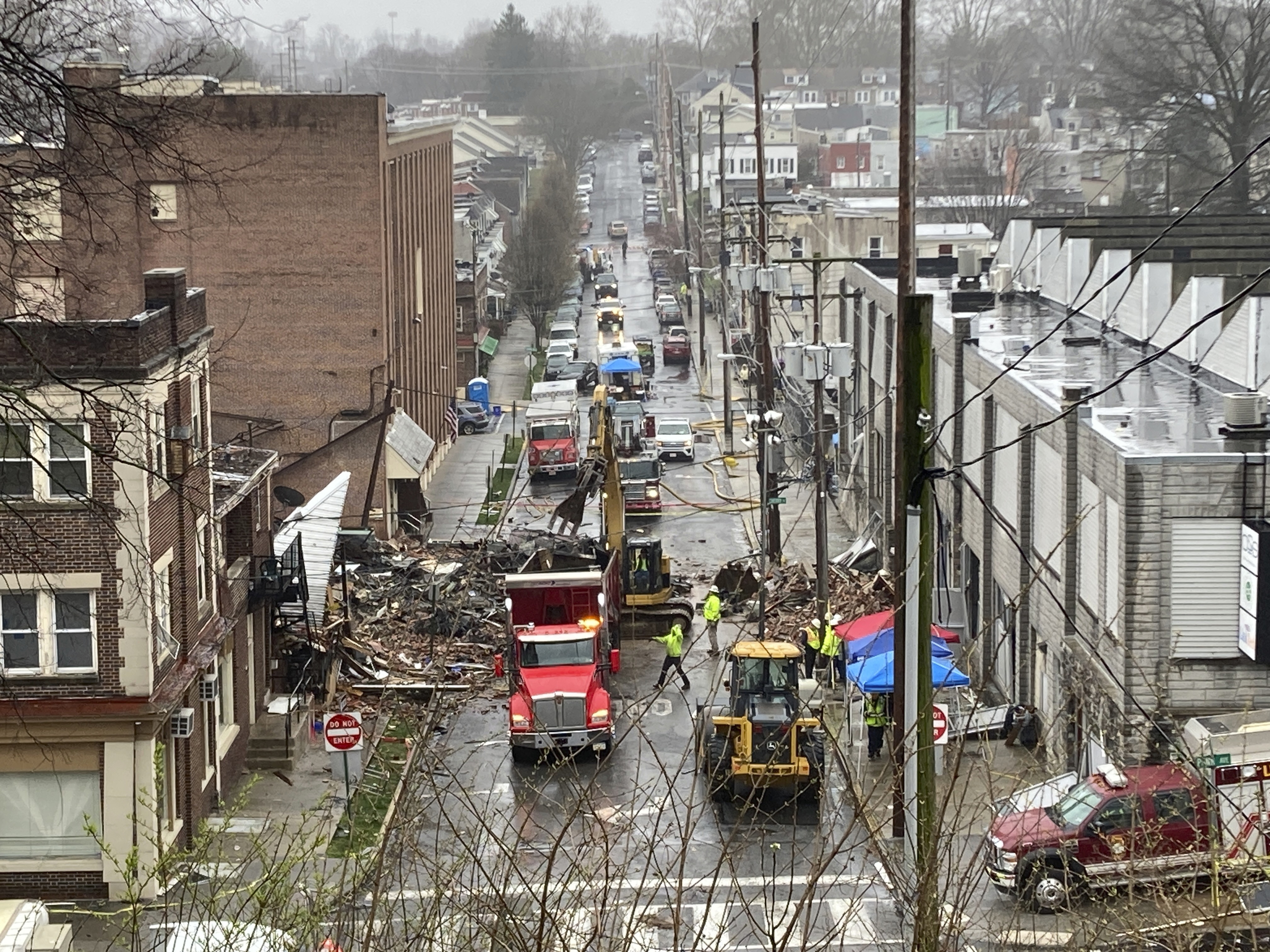 Personal de emergencia y equipo pesado en el lugar de una explosión mortal en una fábrica de chocolate en West Reading, Pensilvania, el sábado 25 de marzo. (AP Photo/Michael Rubinkam)