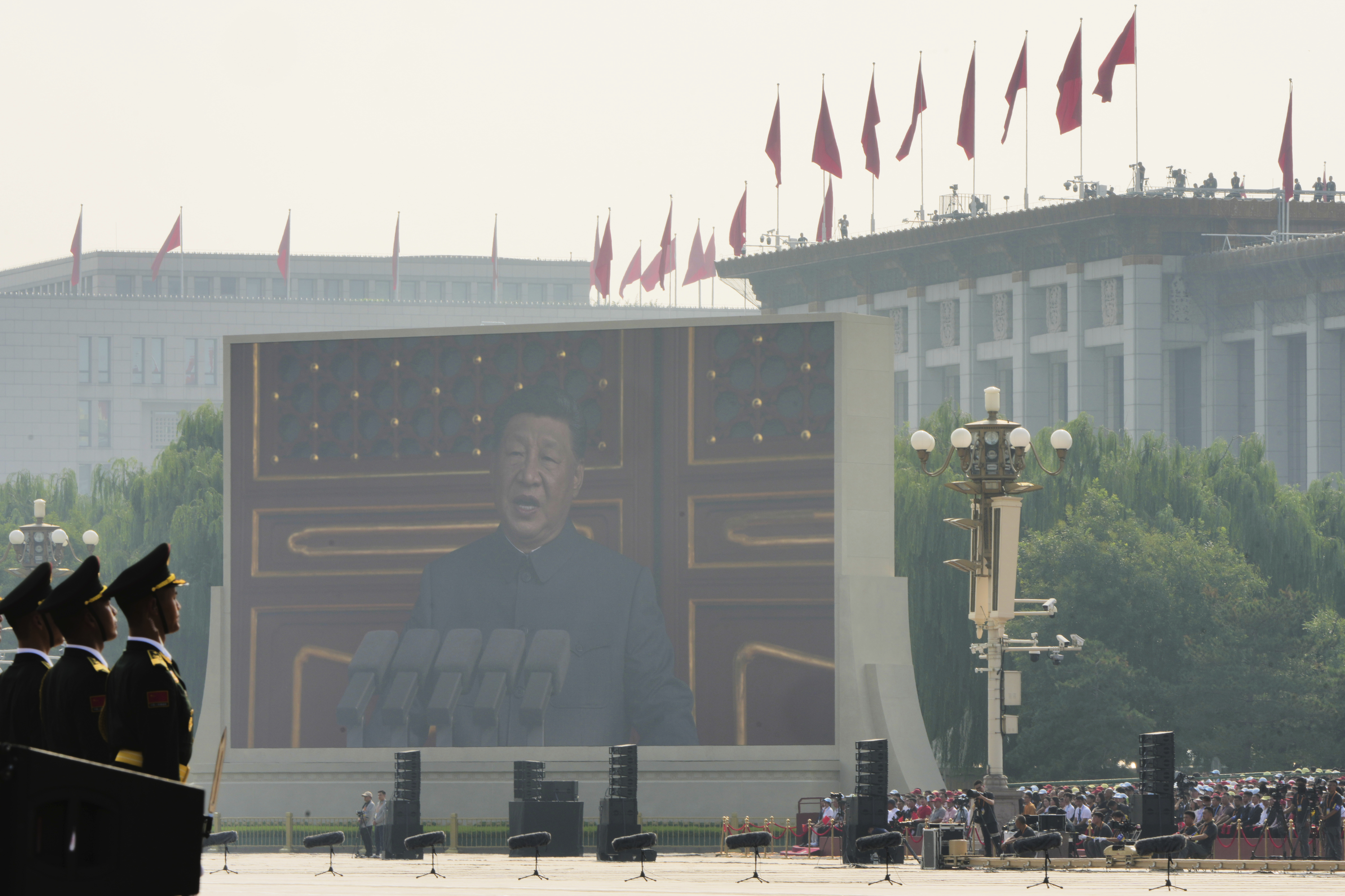 Chinese President Xi Jinping is seen speaking on a giant screen ahead of the military parade.
