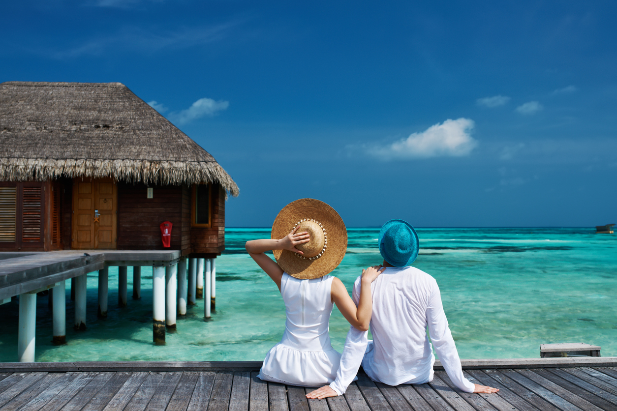 Couple on a tropical holiday with overwater bungalow / bure | Honeymoon in Maldives