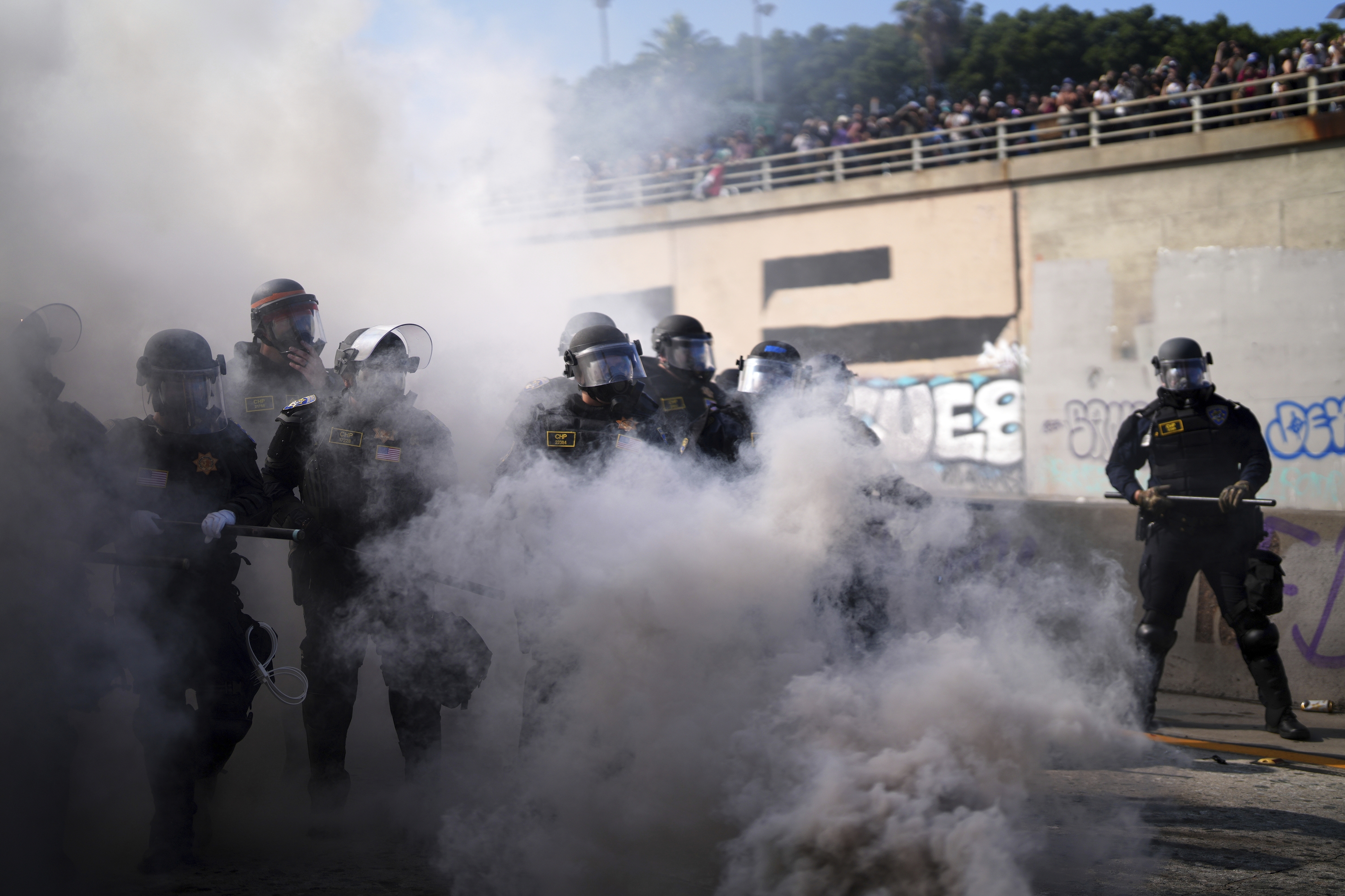 Police are seen through smoke on the 101 Freeway.