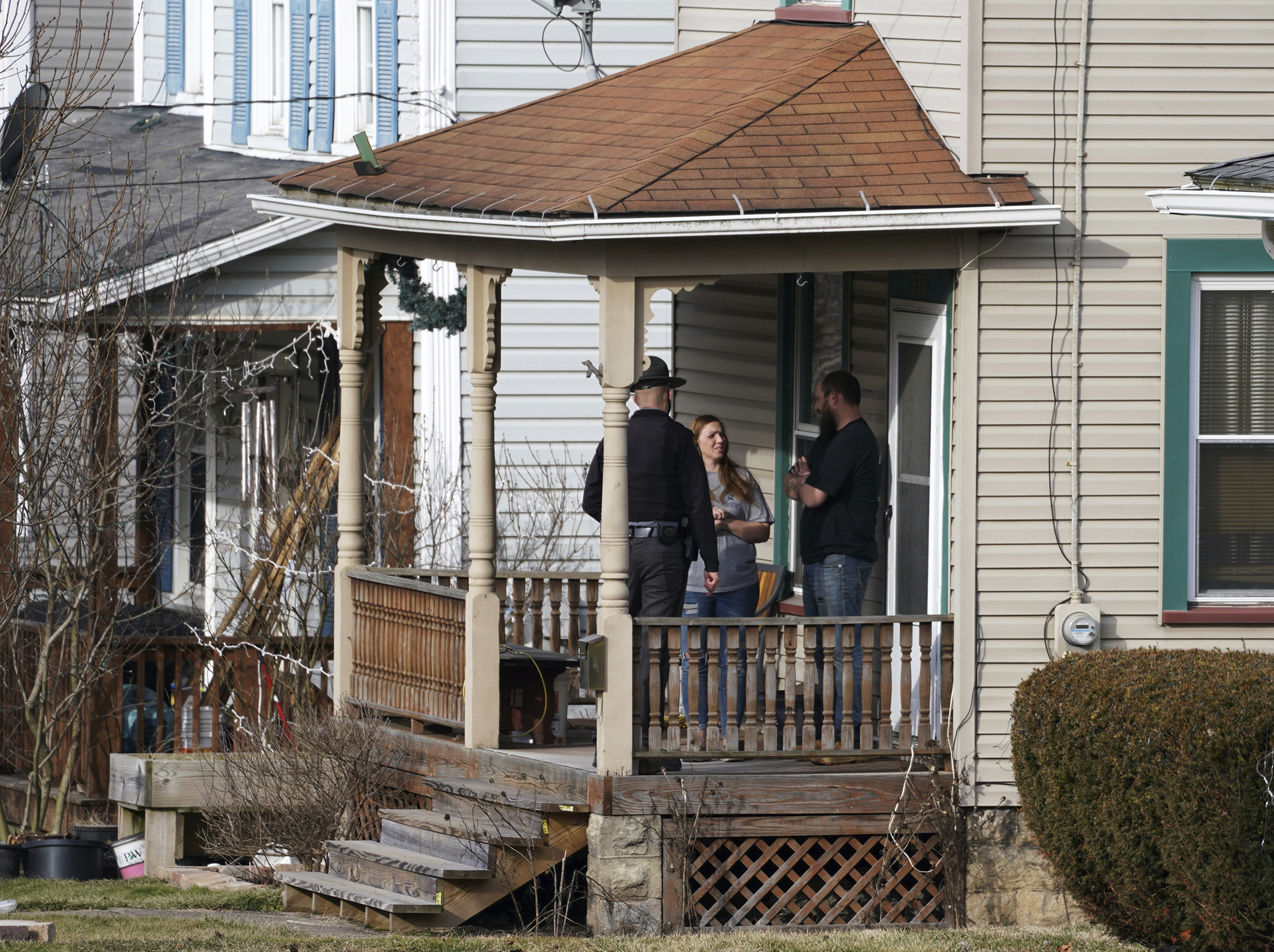 An Ohio state trooper goes door to door telling residents to leave downtown East Palestine, Ohio, on Sunday, Feb. 5, 2023. 