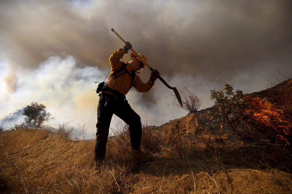 A firefighter works to control the spread of the Hughes Fire in Castaic, Calf., Wednesday, Jan. 22, 2025. (AP Photo/Ethan Swope)