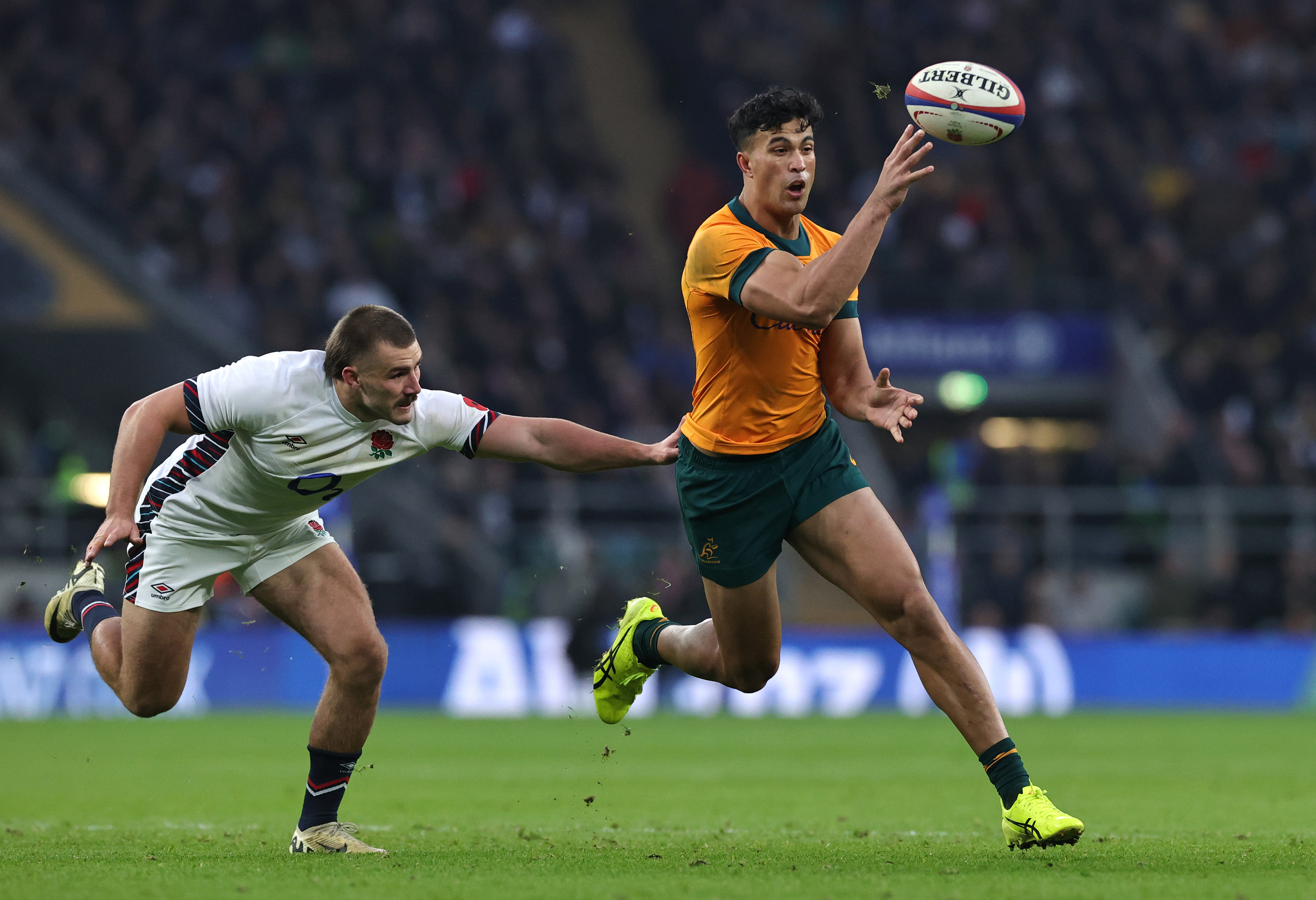 Joseph-Aukuso Suaalii of Australia offloads for teammate Tom Wright's try.