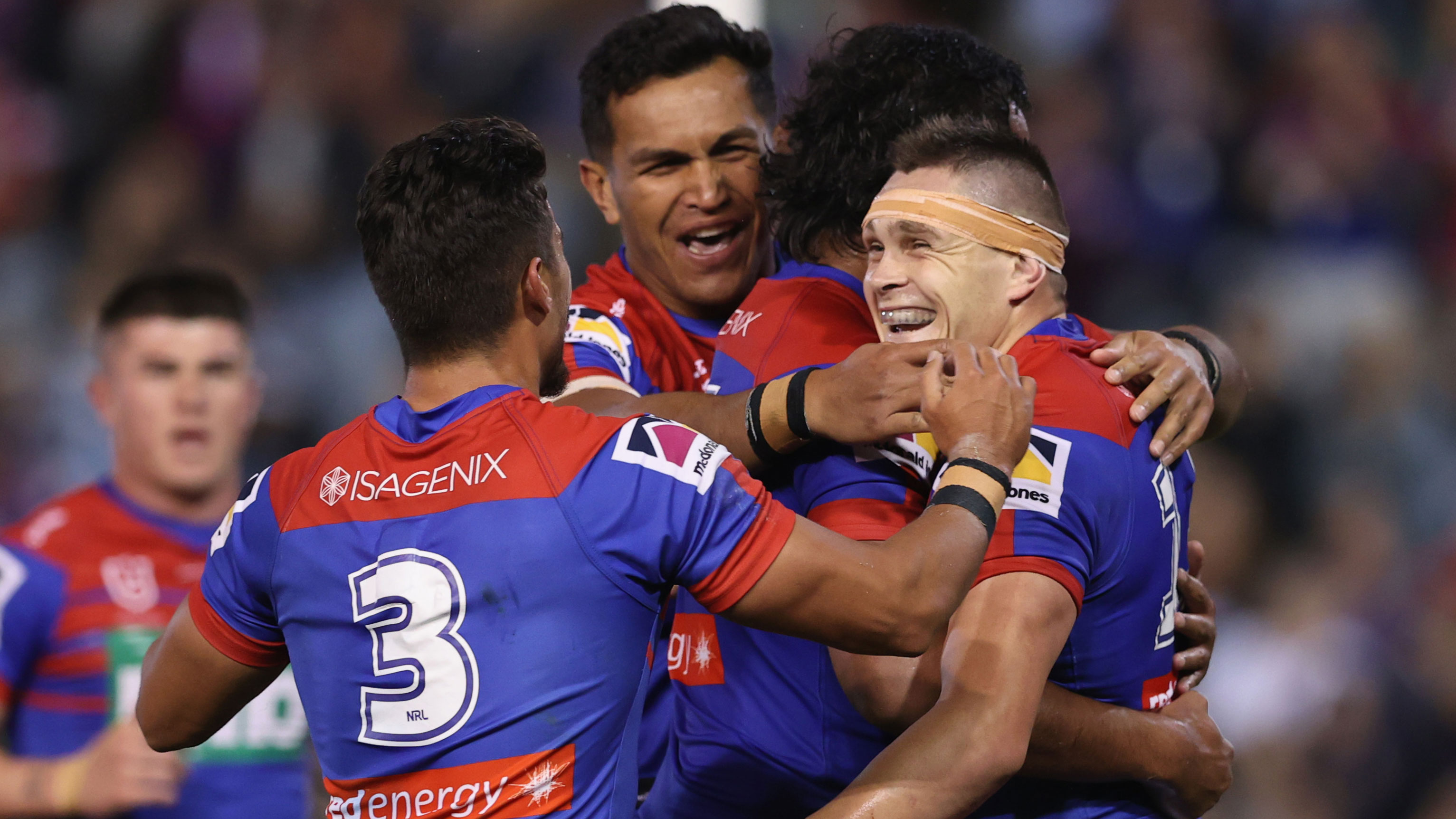 Brodie Jones celebrates a try with Knights teammates.