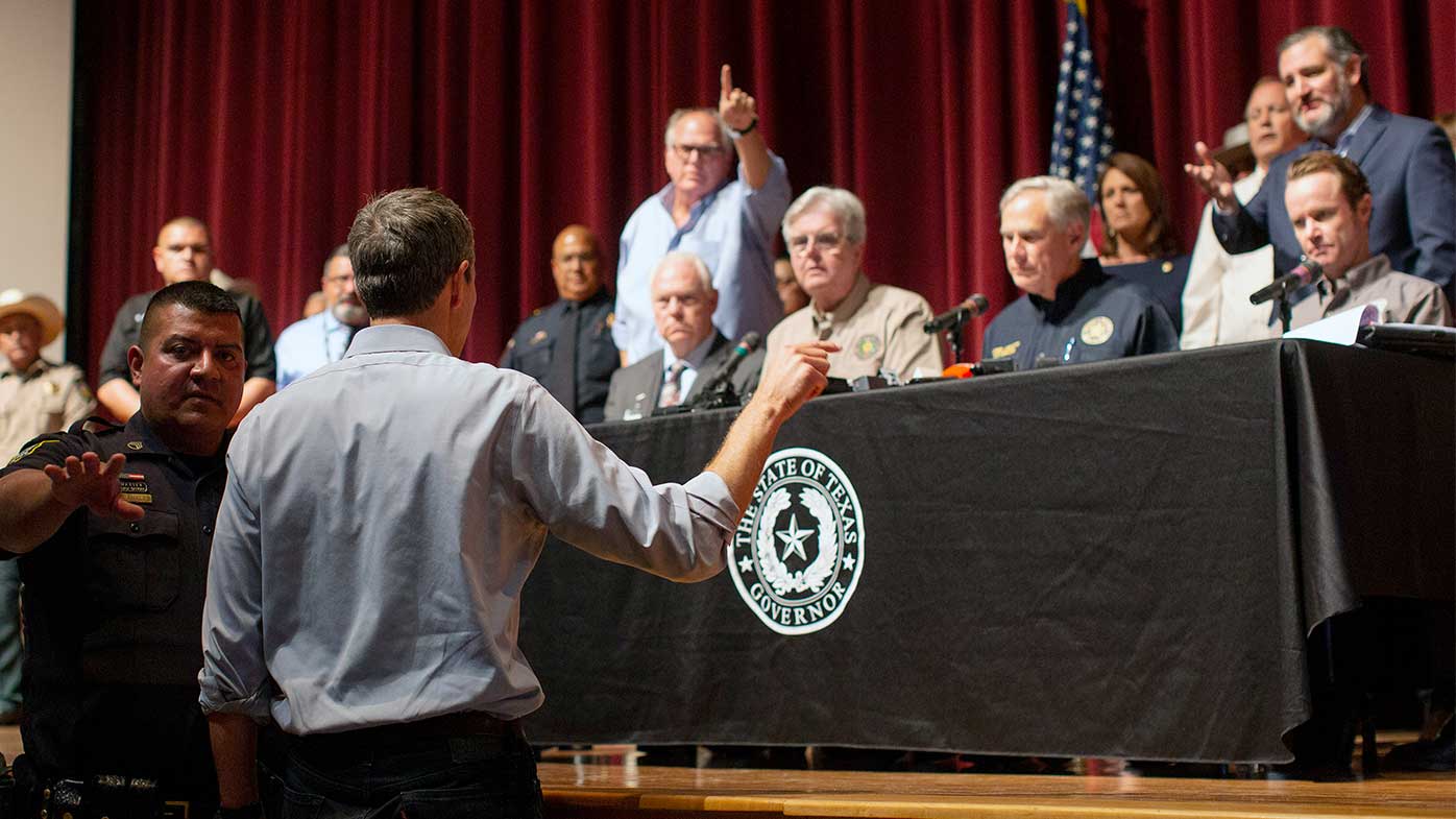 Beto O'Rourke confronting the state's leadership, including Governor Greg Abbott.