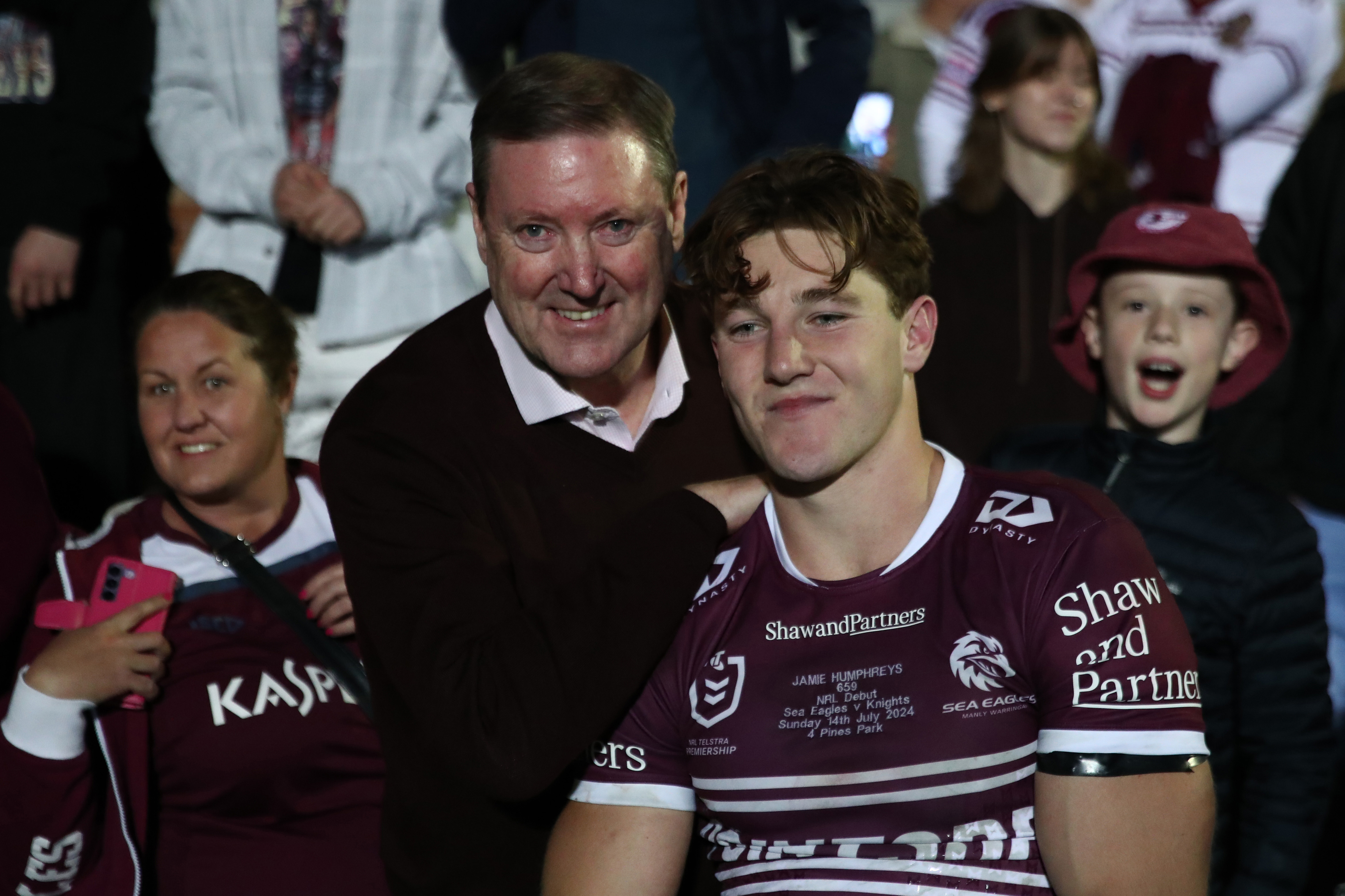 Jamie Humphreys, then of the Sea Eagles, poses with his father Stephen Humphreys after his 2024 NRL debut against the Knights.