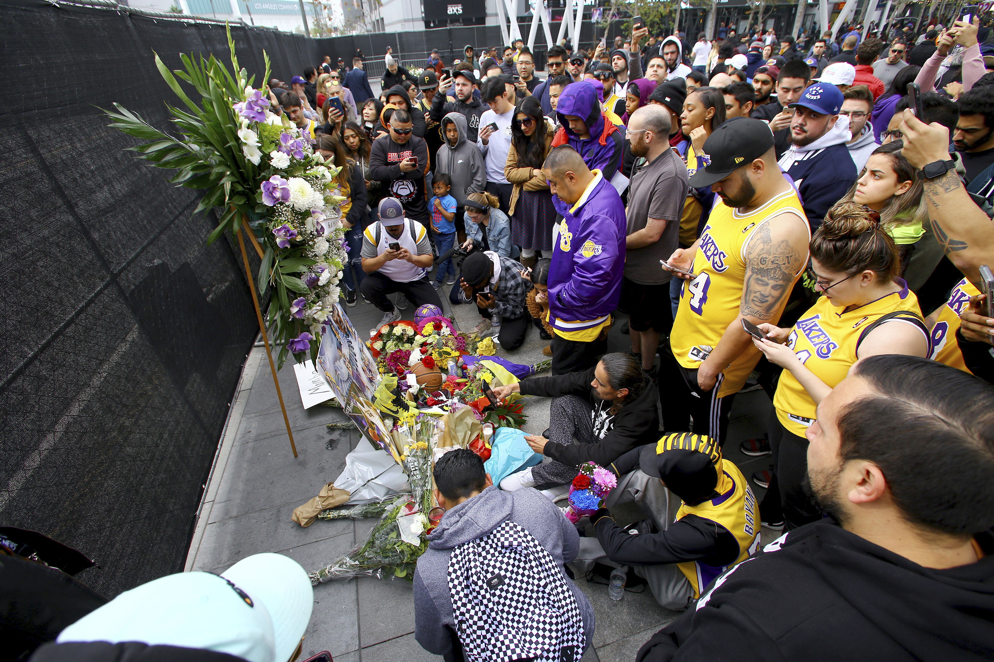 Fans of Kobe Bryant mourn at a memorial to him in front of Staples Center, home of the Los Angeles Lakers, after word of the Lakers star's death in a helicopter crash.