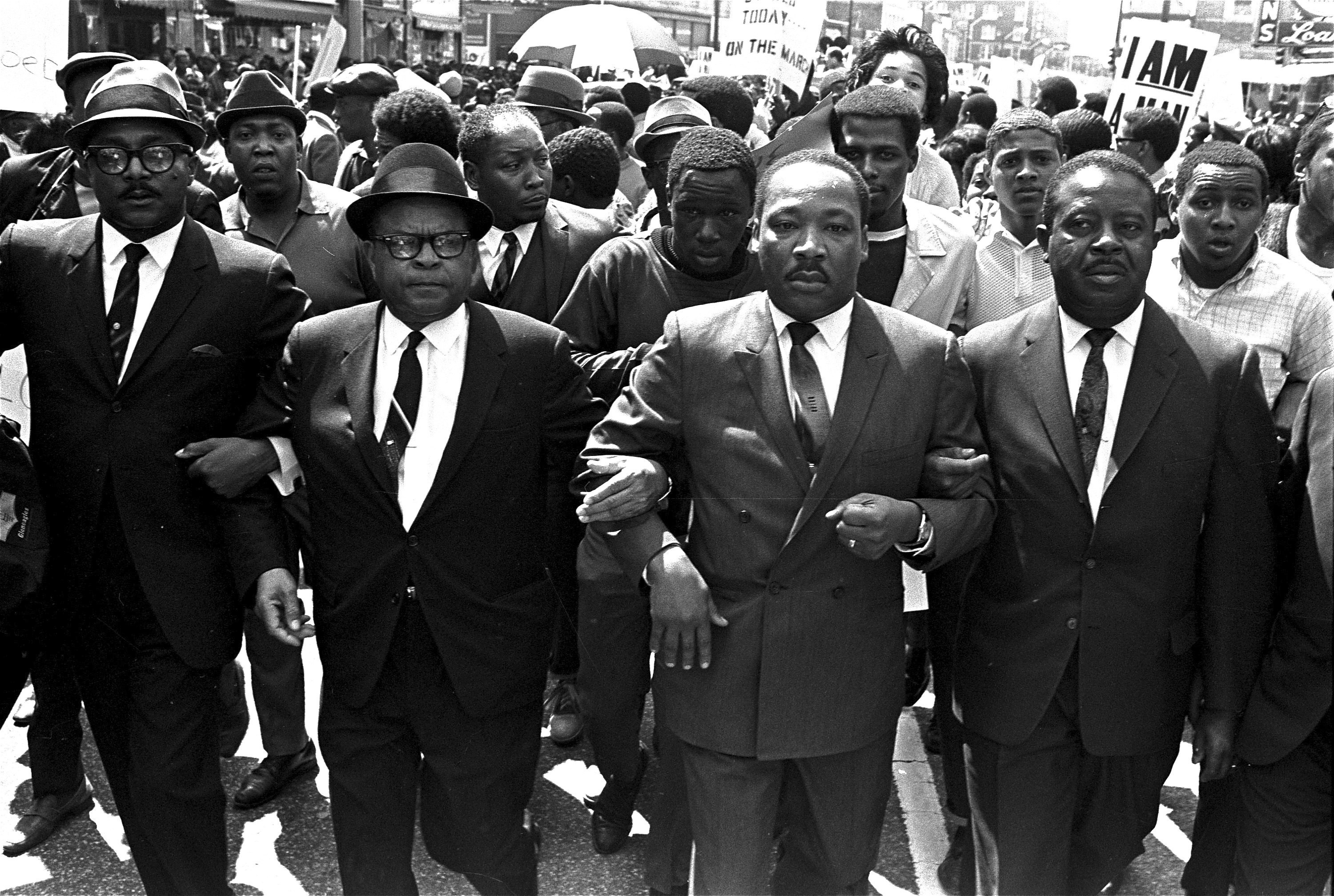 The Reverend Ralph Abernathy, right, and Bishop Julian Smith, left, flank Dr. Martin Luther King, Jr, during a civil rights march in Memphis, Tennessee.