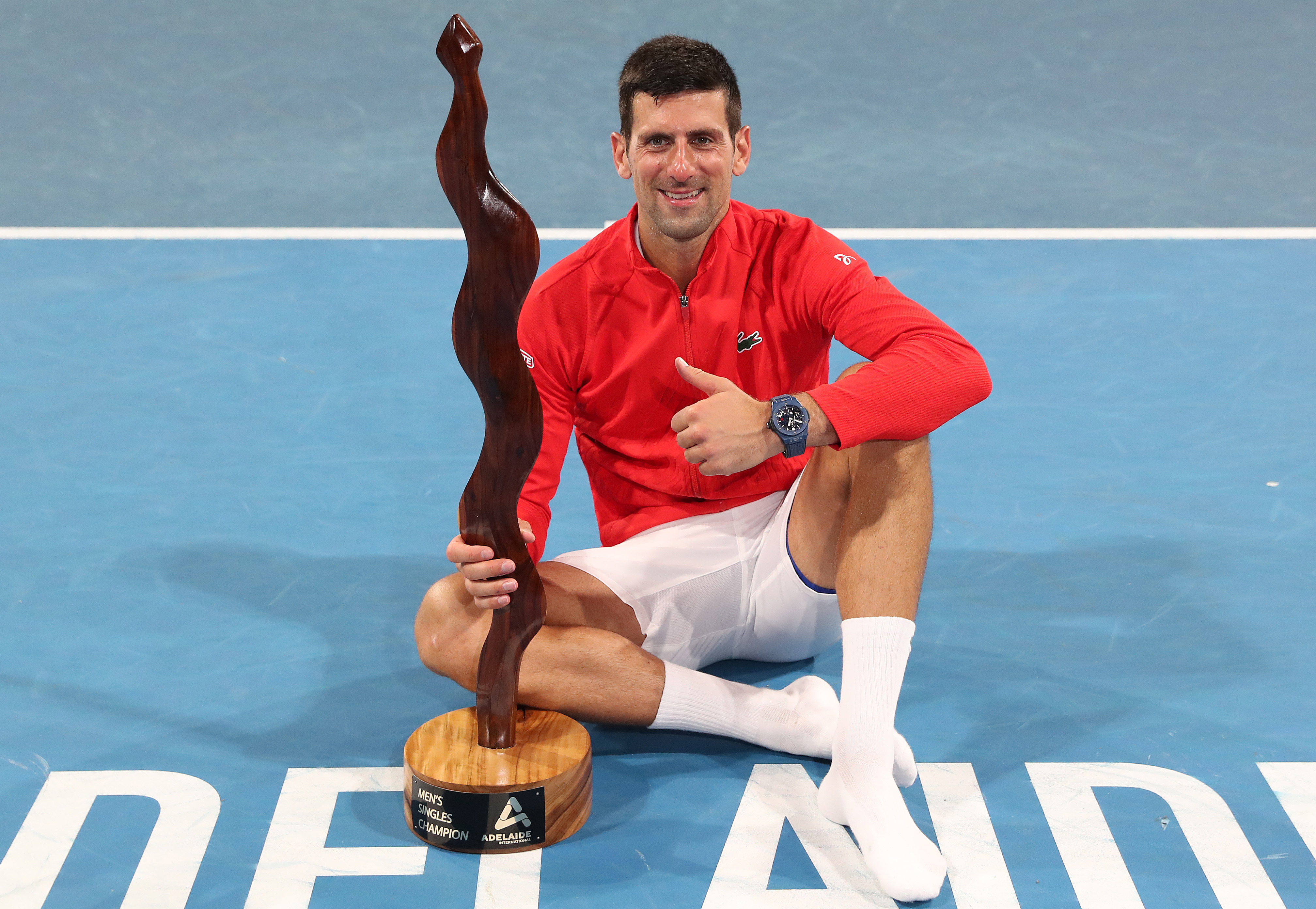 Novak Djokovic poses with his trophy after taking out the Adelaide International.
