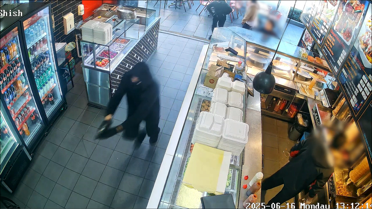 Two men with masks and clad in black stormed into the kebab shop with guns.