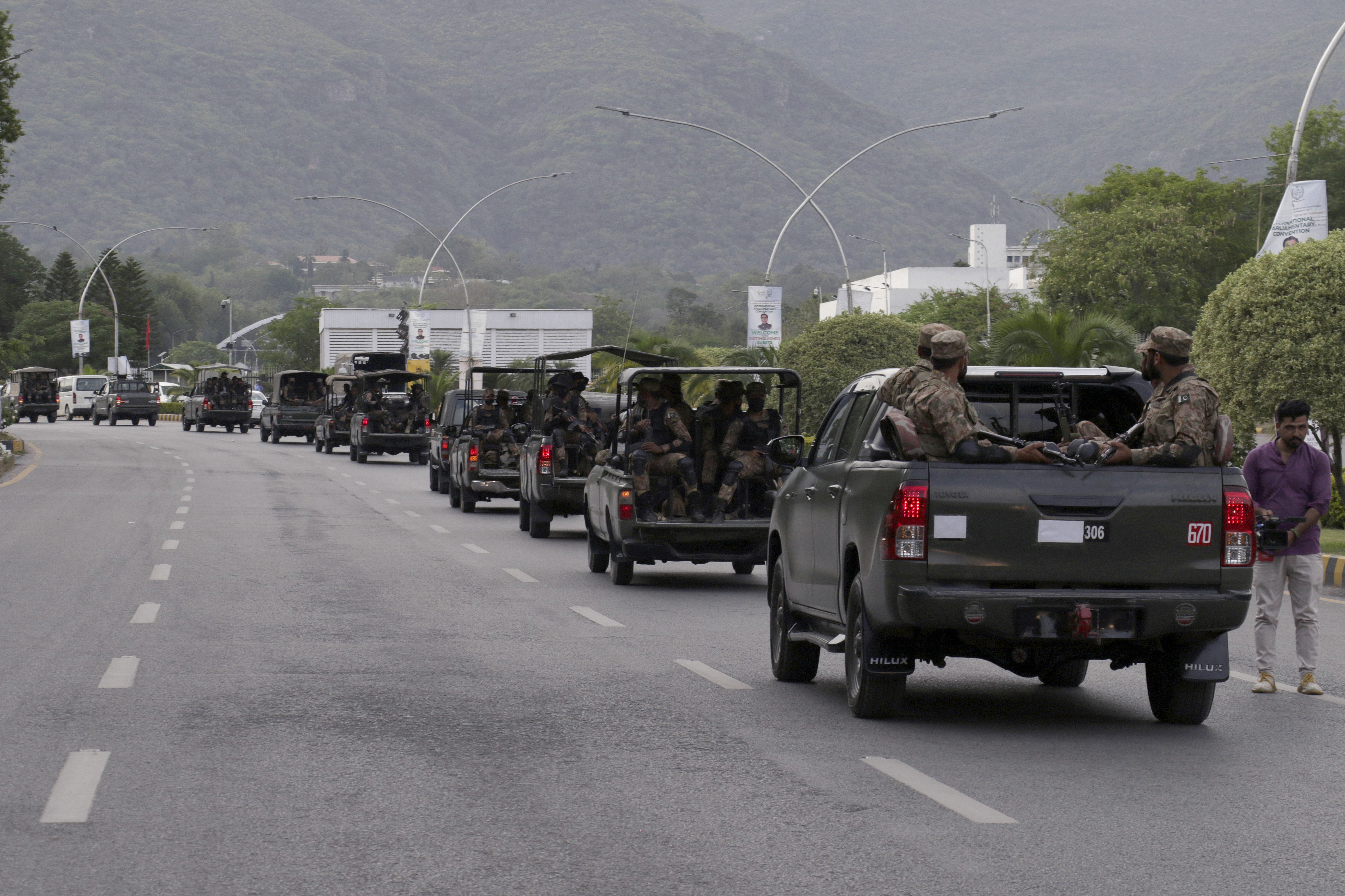 A convey of army troops patrol at a road to ensure security after clashes between police and supporters of Pakistan's former Prime Minister Imran Khan, in Islamabad, Pakistan, Thursday, May 11, 2023.   