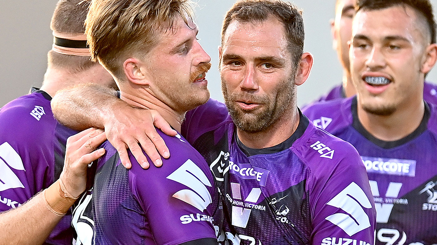 Cameron Munster of the Storm is congratulated by Cameron Smith after scoring a try