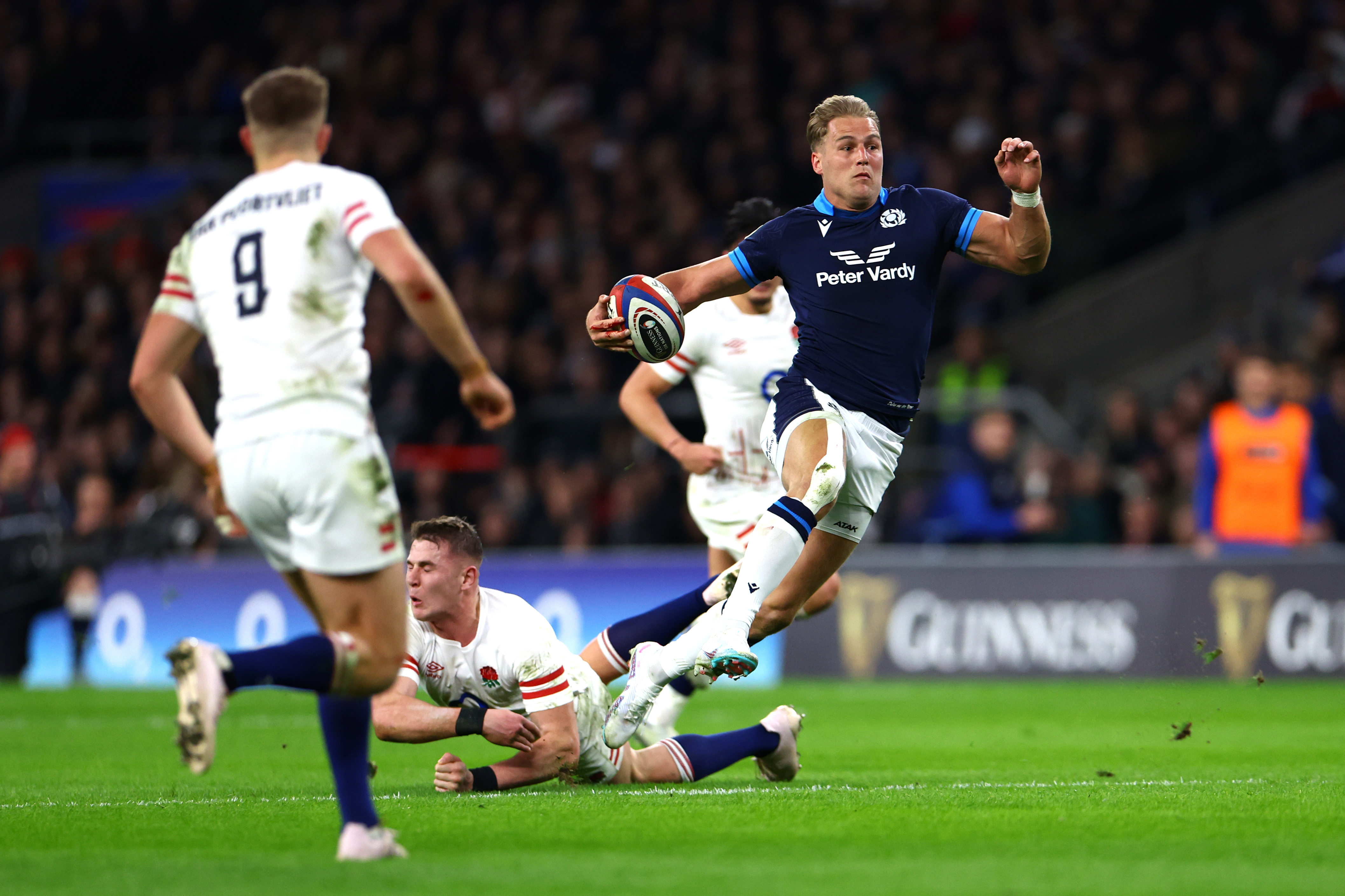 Duhan van der Merwe of Scotland breaks with the ball before touching down.