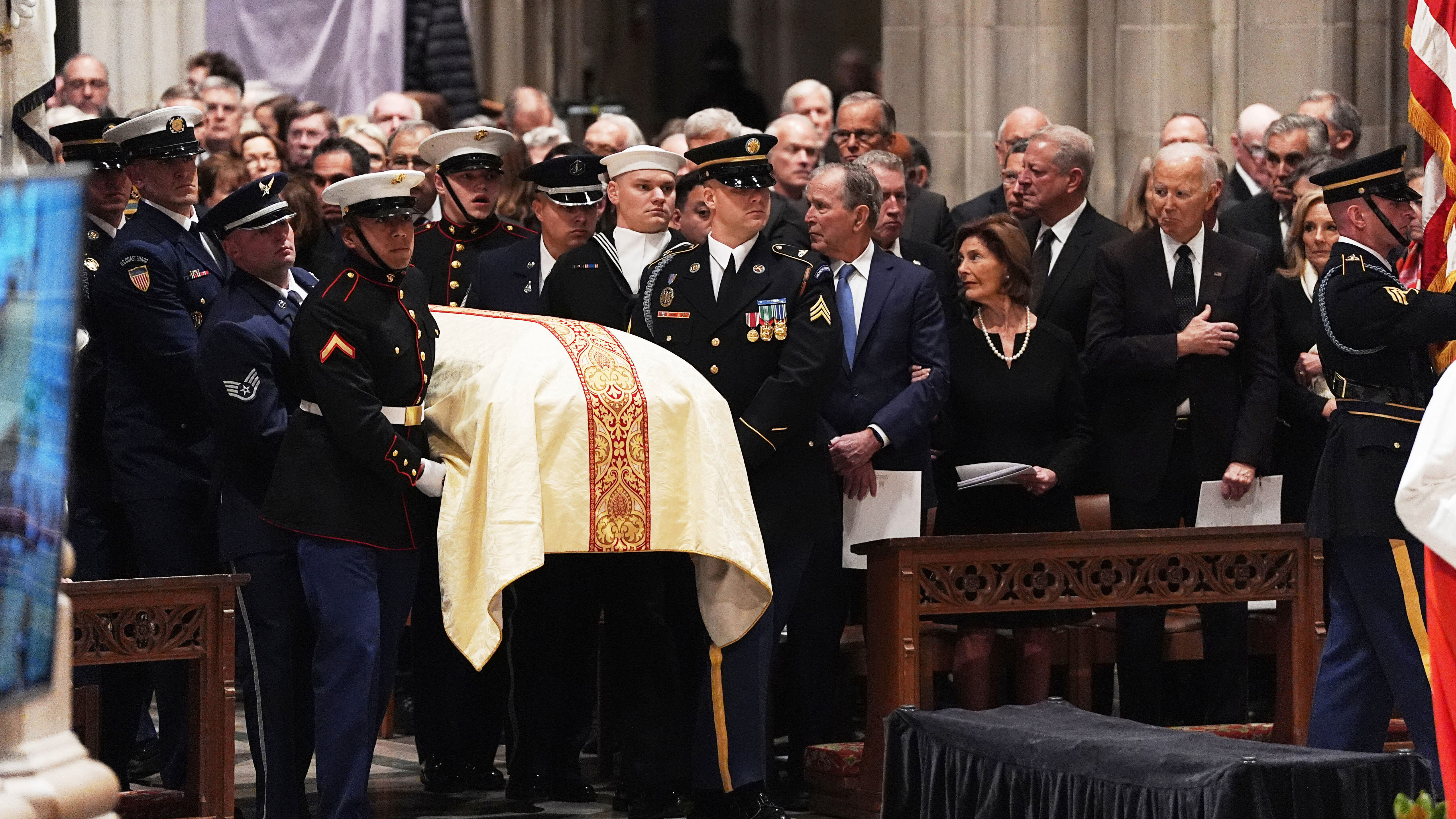 Former Presidents front row from left, George W. Bush with Laura Bush and Joe Biden with Jill Biden, look on as a joint services body bearer team arrive with the casket of former Vice President Dick Cheney at the Washington National Cathedral.
