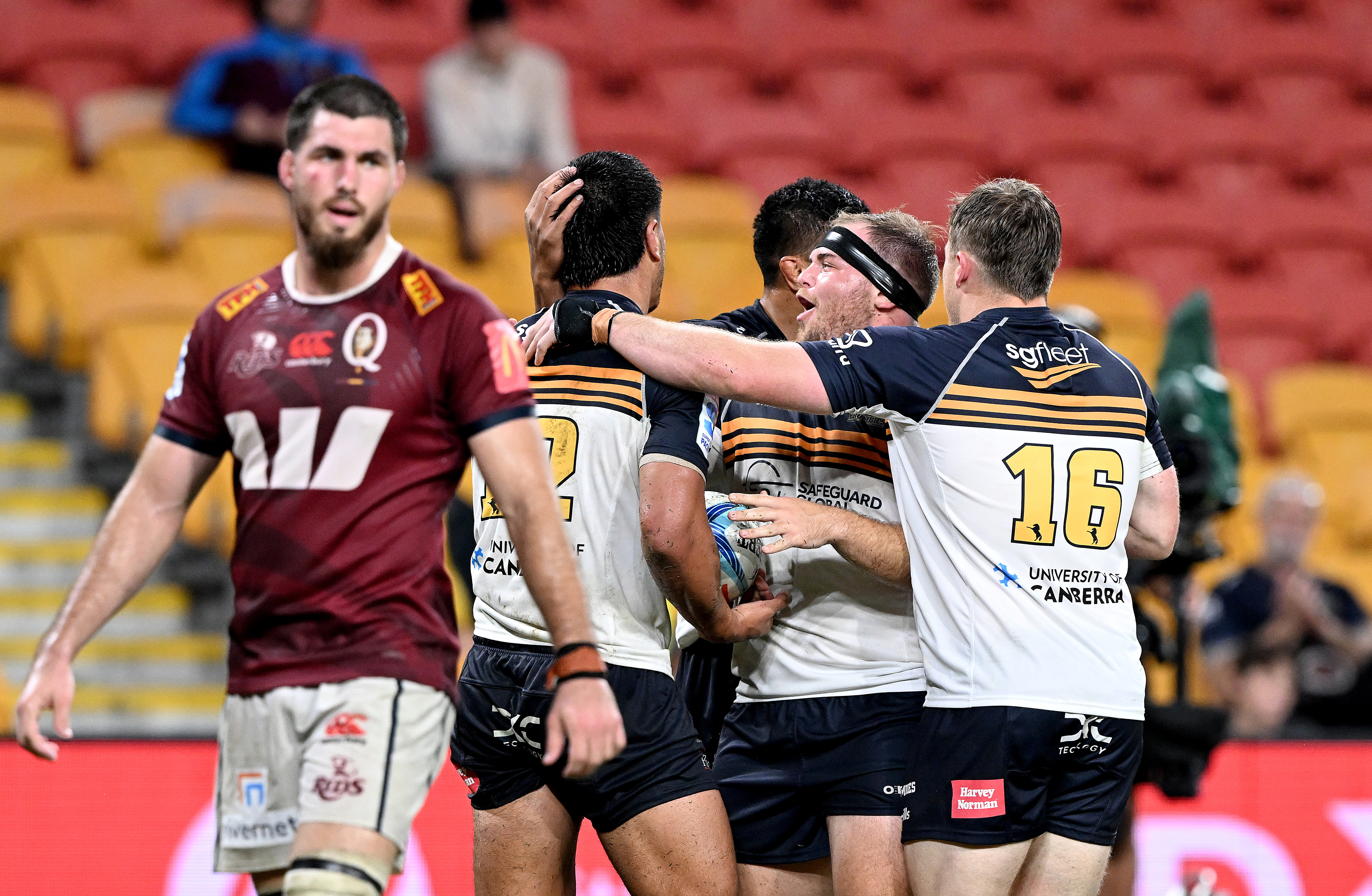 Tamati Tua of the Brumbies celebrates with team mates after scoring a try.