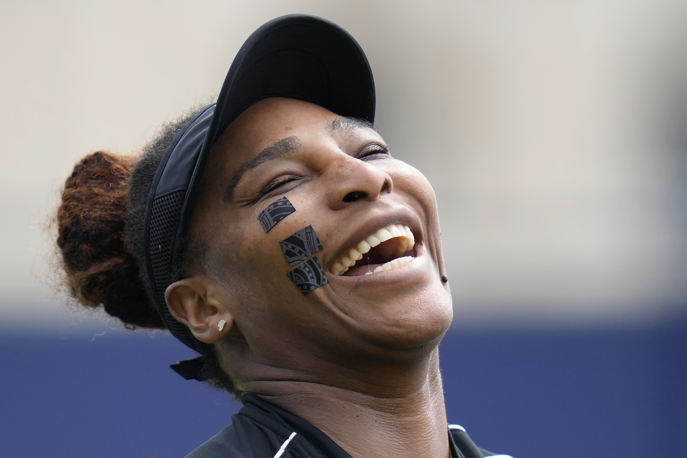 Serena Williams of the United States laughs during a practice session at the Eastbourne International tennis tournament in Eastbourne, England, Tuesday, June 21, 2022. Serena Williams will play a doubles match with partner Ons Jabeur of Tunisia at the tournament later Tuesday. (AP Photo/Kirsty Wigglesworth)