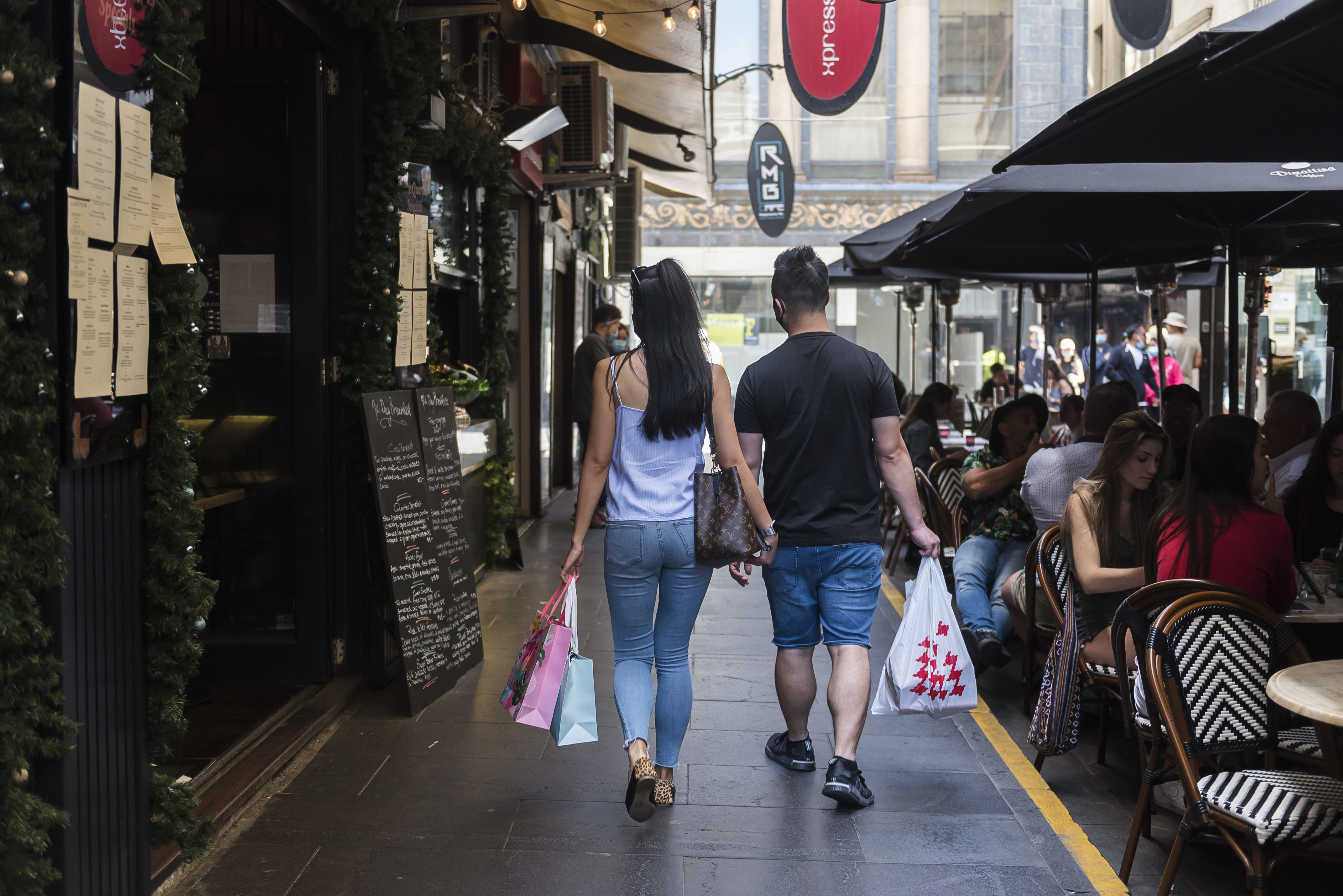 Shoppers walking down Degraves Street during the Boxing Day sales on December 26, 2020 in Melbourne, Australia. Australians celebrate Boxing Day with many taking advantage of the post-Christmas sale prices in what is usually the busiest day of the year for retailers in Australia. Extra safety protocols have been introduced this year, due to the ongoing COVID-19 pandemic. (Photo by Naomi Rahim/Getty Images)