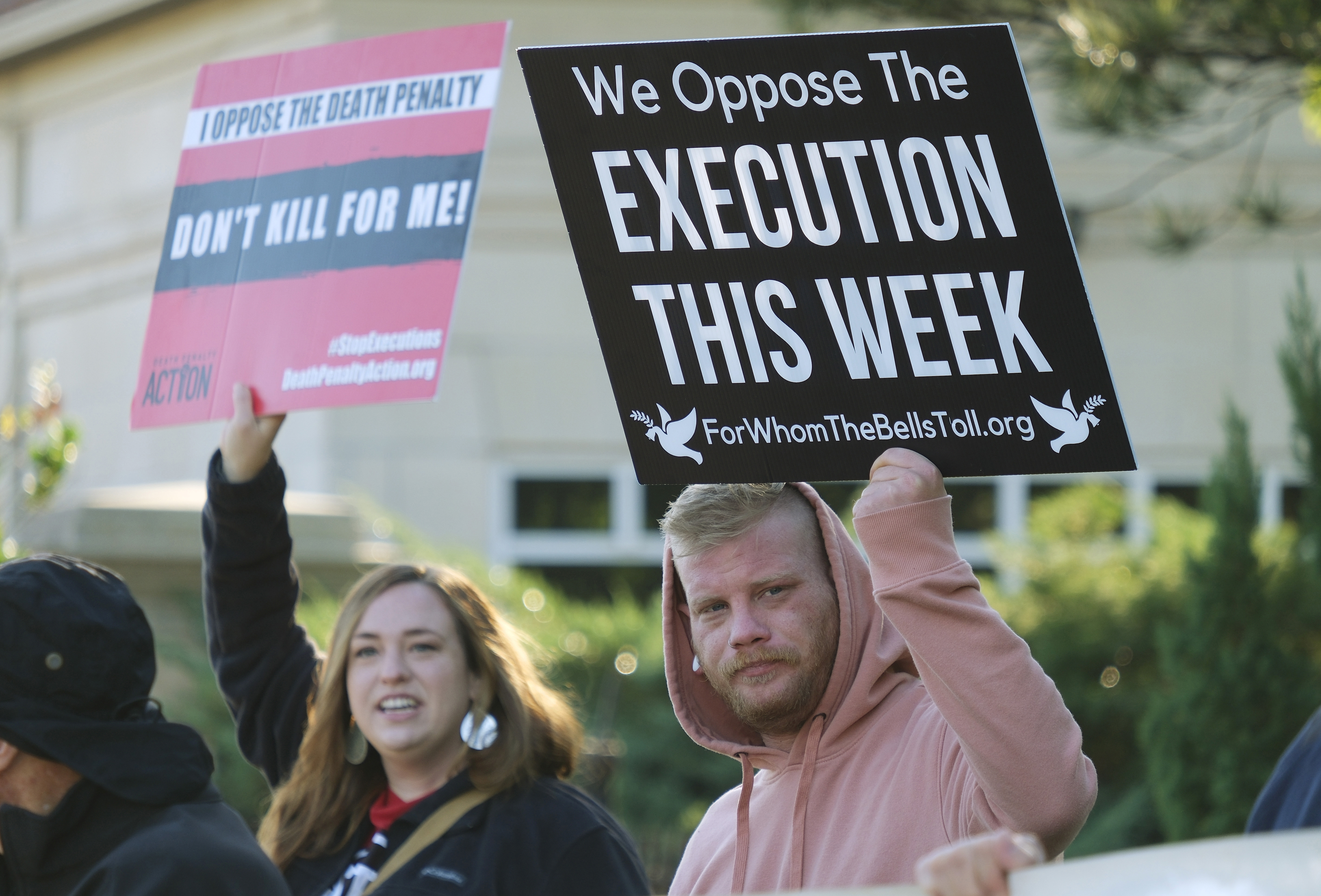 FILE - Mirabai Hull, left, and Matthew Harris protest against the death penalty and the execution of Benjamin Cole outside of the Oklahoma Governor's Mansion on Oct. 20, 2022, in Oklahoma City. Public support and use of the death penalty in 2022 continued its more than two-decade long decline in the U.S., and many of the executions that were carried out were botched or highly problematic, according to an annual report on capital punishment released Friday, Dec. 16. (Doug Hoke/The Oklahoman via A