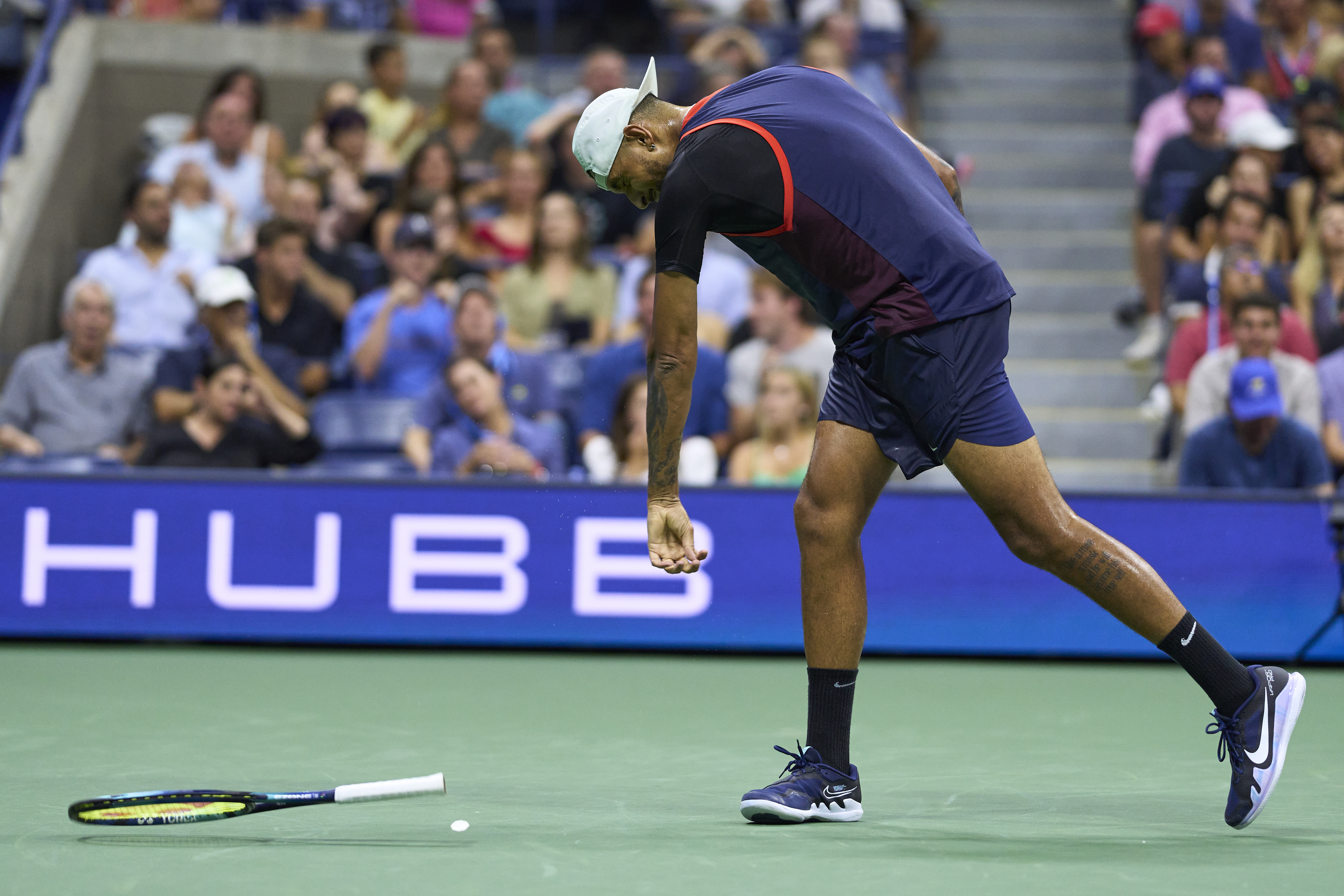 Aussie tennis star Nick Kyrgios throws his racquet into the court during the US Open.