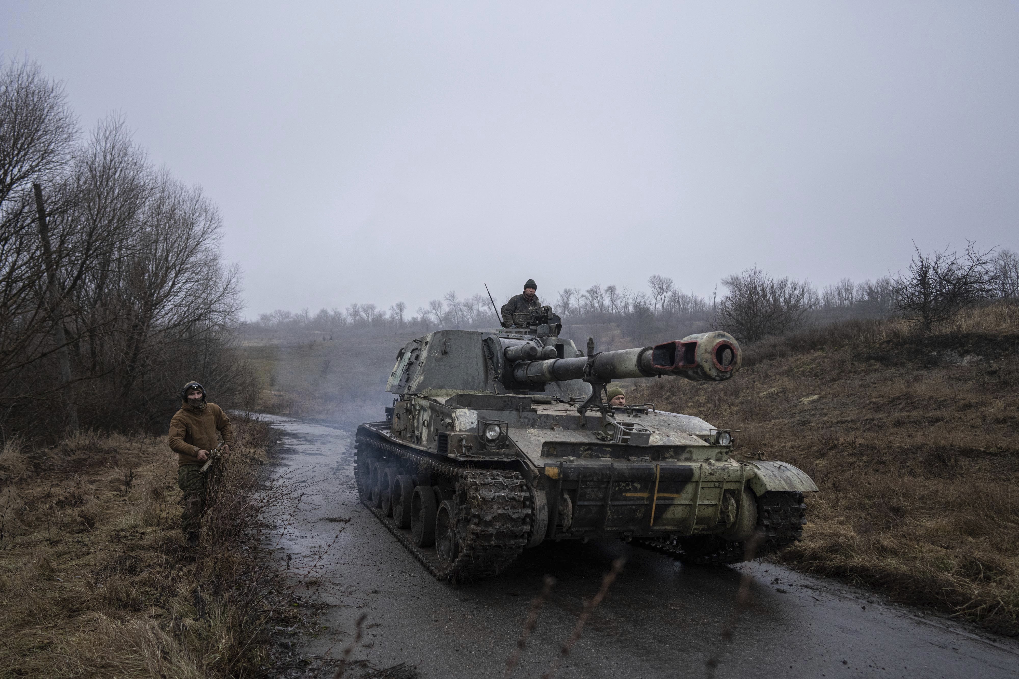 A Ukrainian self-propelled artillery changes position after shooting towards Russian forces at a frontline in Kharkiv region, Ukraine, Saturday, Dec. 24, 2022. (AP Photo/Evgeniy Maloletka)