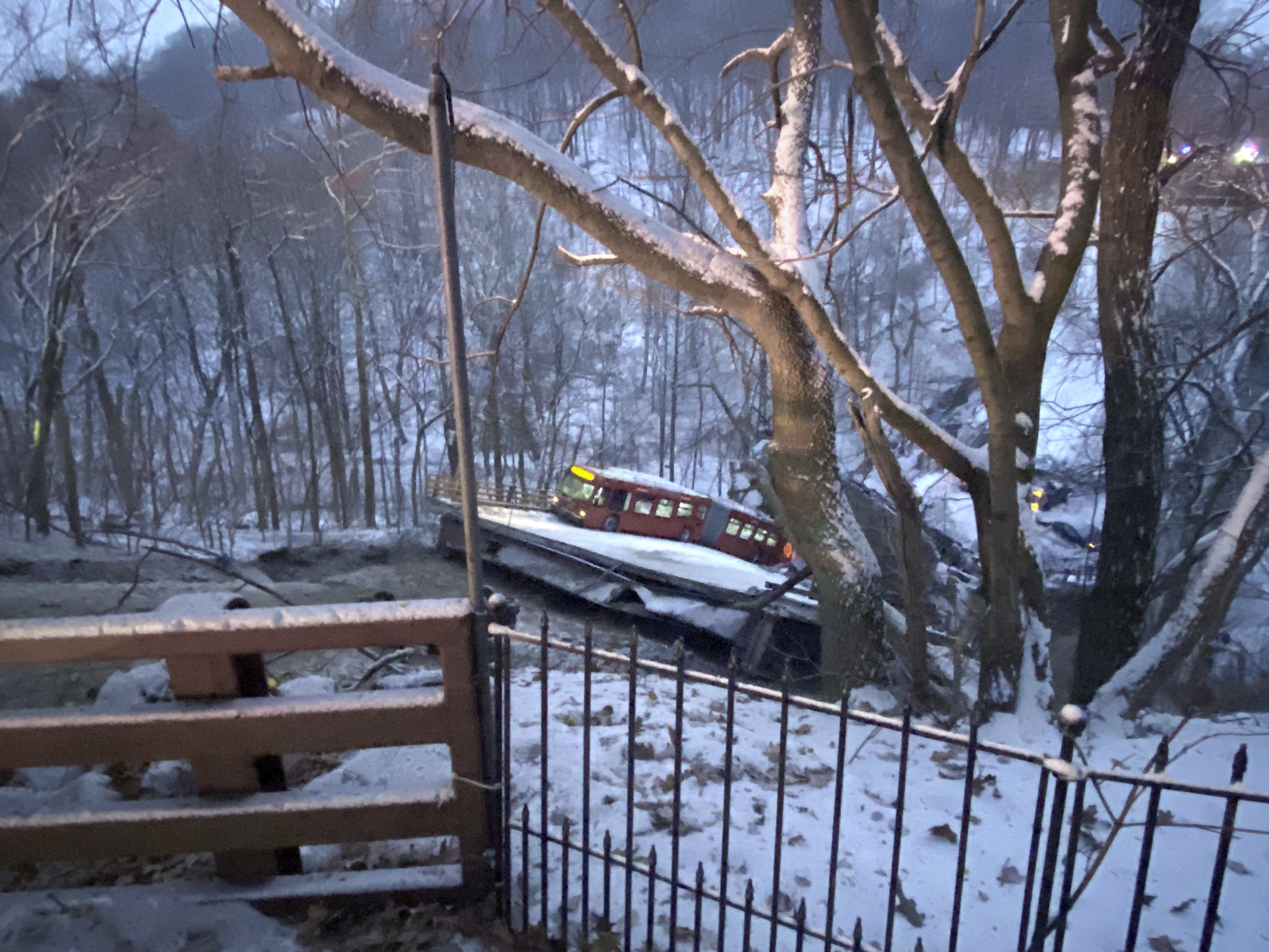 A commuter bus sits upright on a section of a collapsed bridge in Pittsburgh, on Friday, Jan. 28, 2022. 