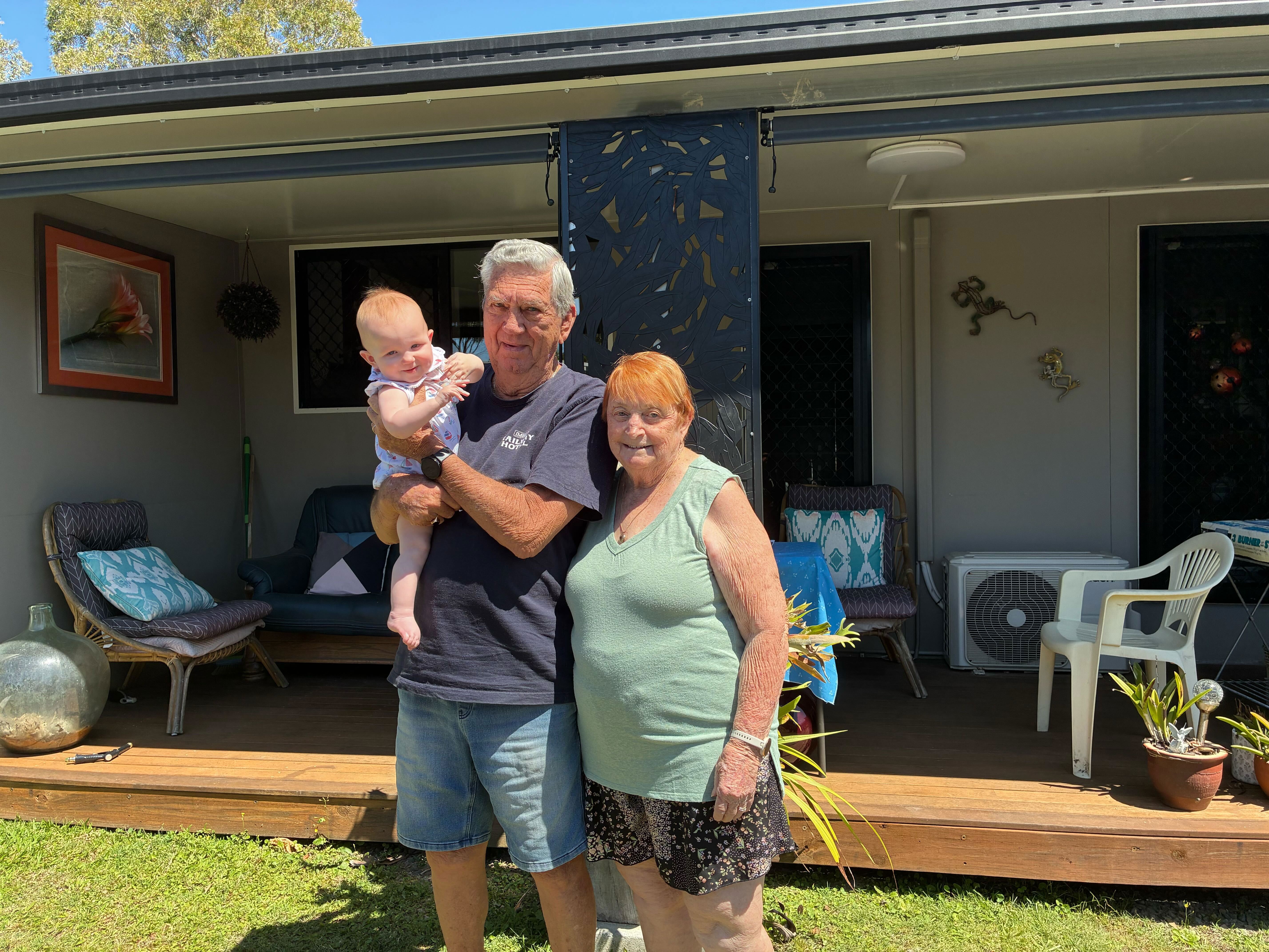 Howard and Shirley Hill with their great-granddaughter outside their beloved Dicky Beach Holiday Park home.