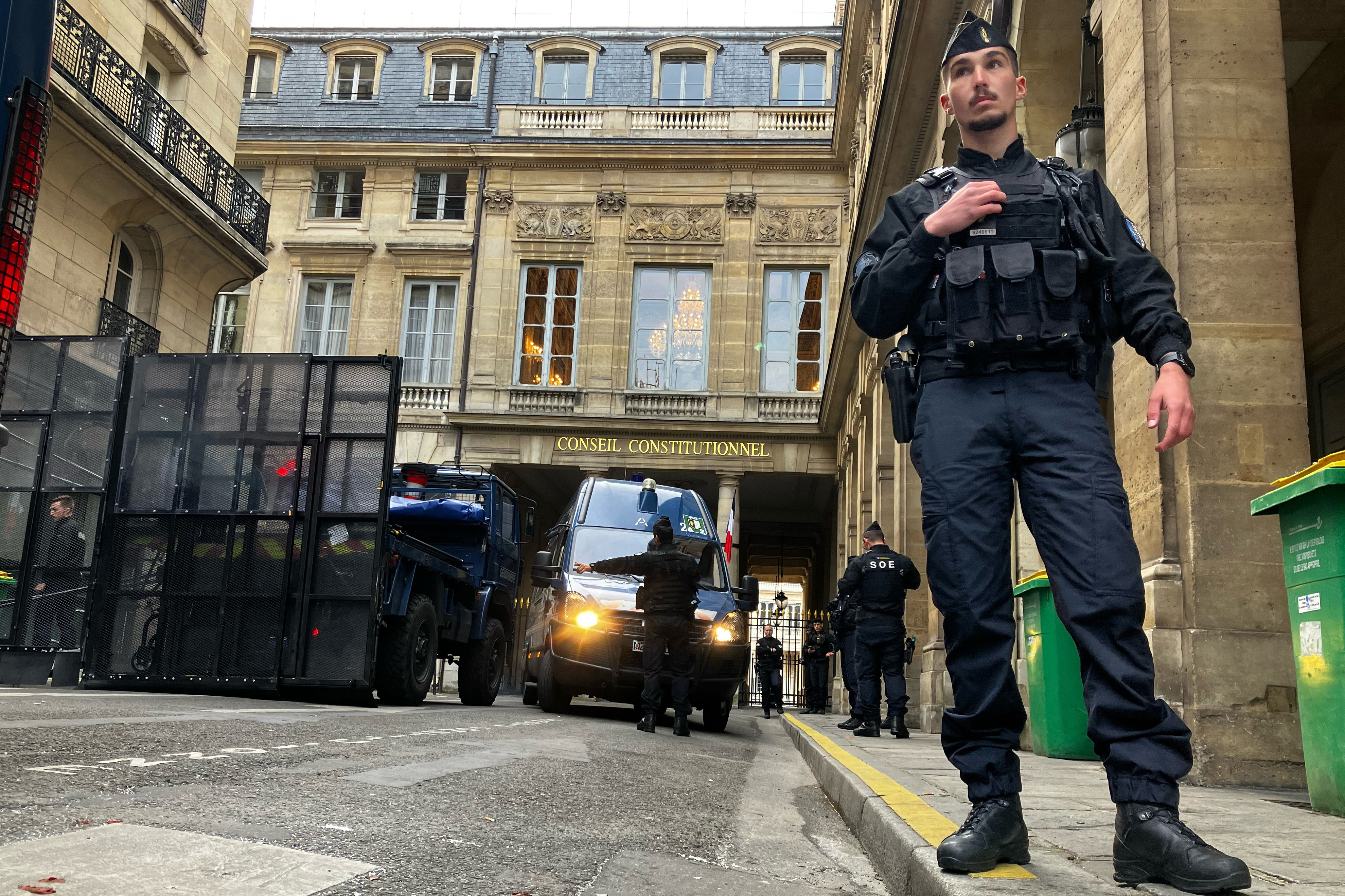 Police forces set up a barricade in front of the Constitutional Council Friday, April 14, 2023 in Paris.