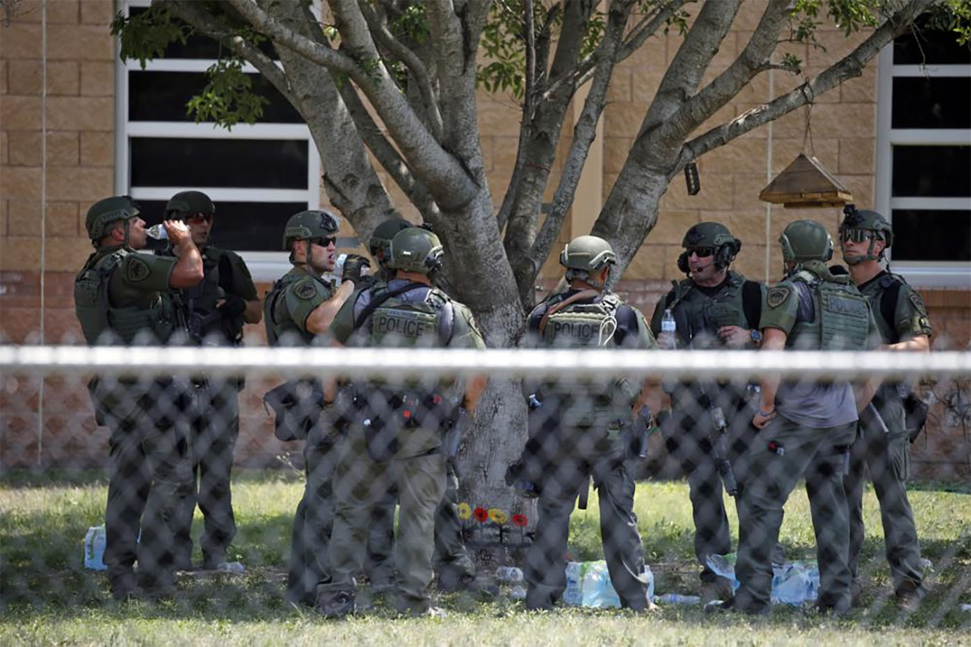 Law enforcement personnel stand outside Robb Elementary School following a shooting, May 24, 2022, in Uvalde, Texas.