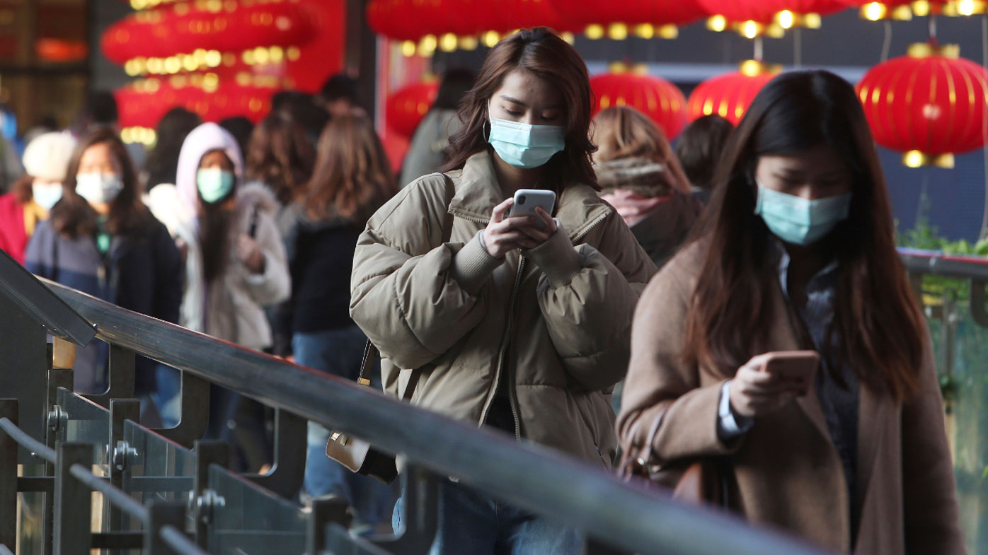 People wear face masks and walk at a shopping mall in Taipei, Taiwan.