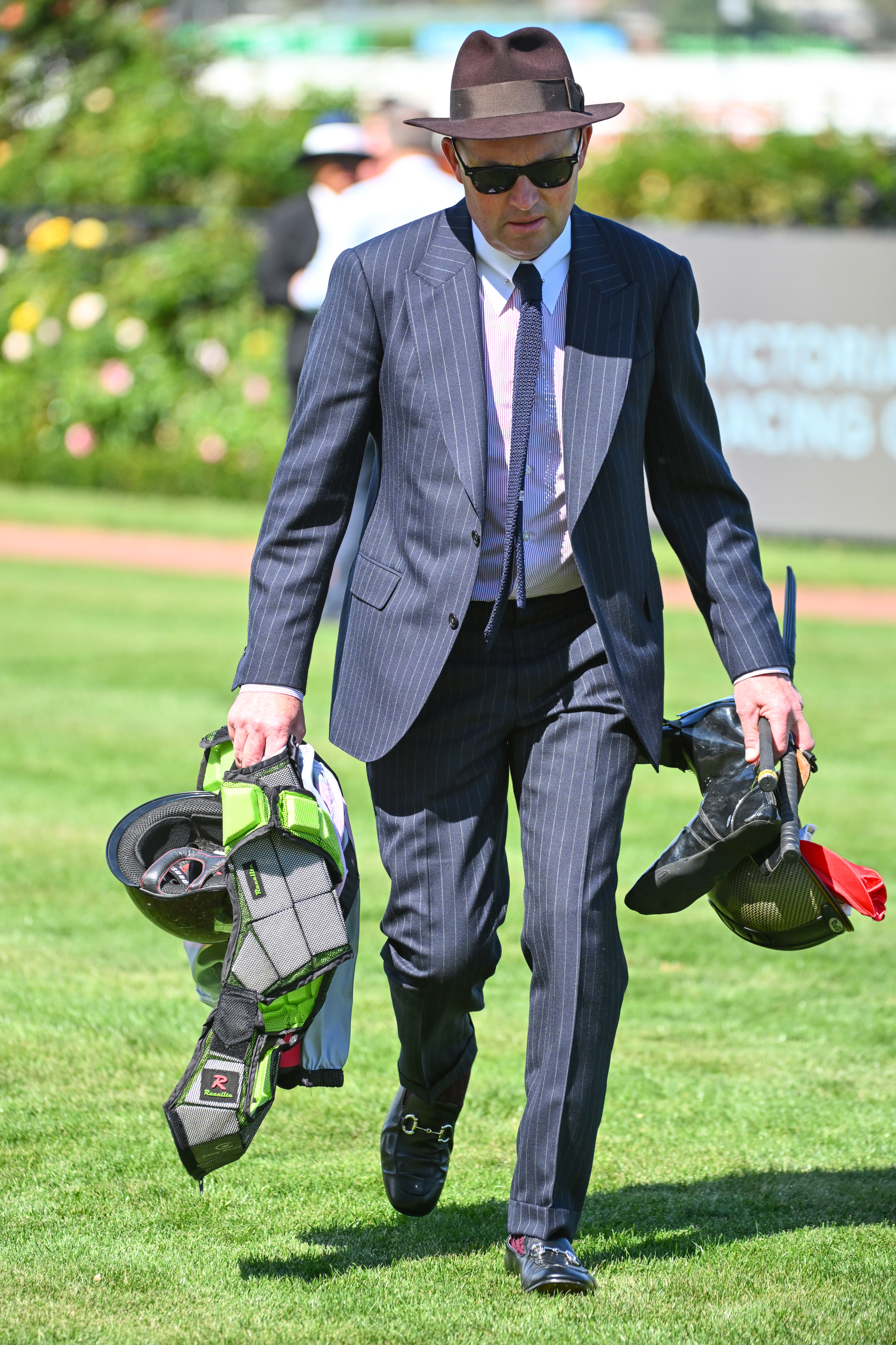 Matt Hyland, the executive officer for the Victorian Jockeys Association, with Craig Williams' riding gear after a fall.