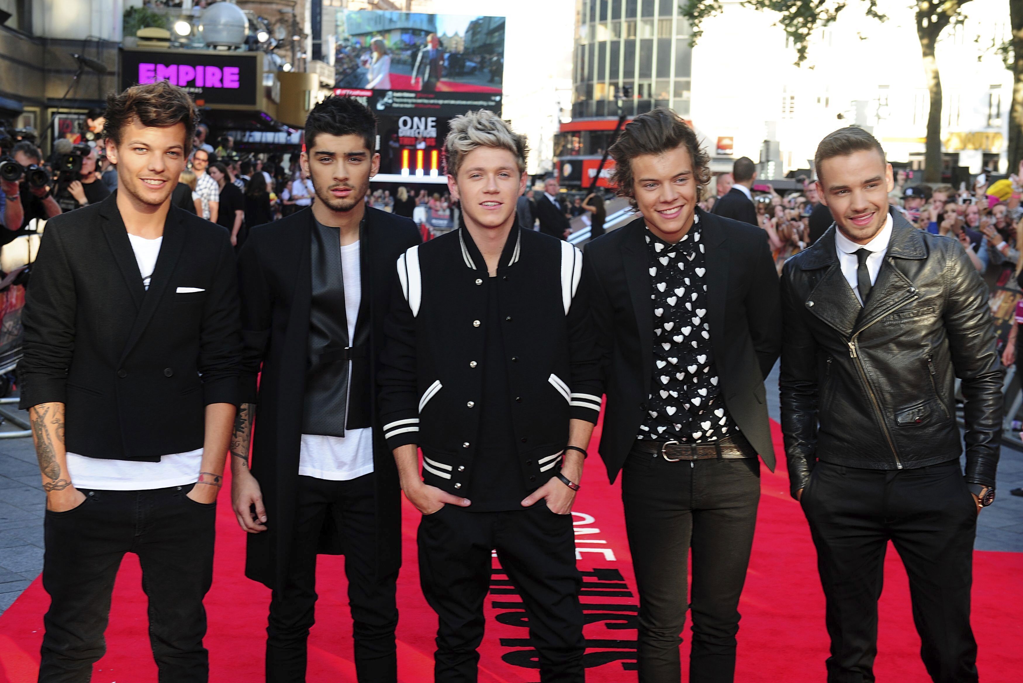 FILE - Louis Tomlinson, from left, Zayn Malik, Niall Horan, Harry Styles and Liam Payne arrive for the World Premiere of "One Direction: This Is Us," at the Empire Leicester Square, in London, Aug. 20, 2013. (Ian West/PA via AP, File)