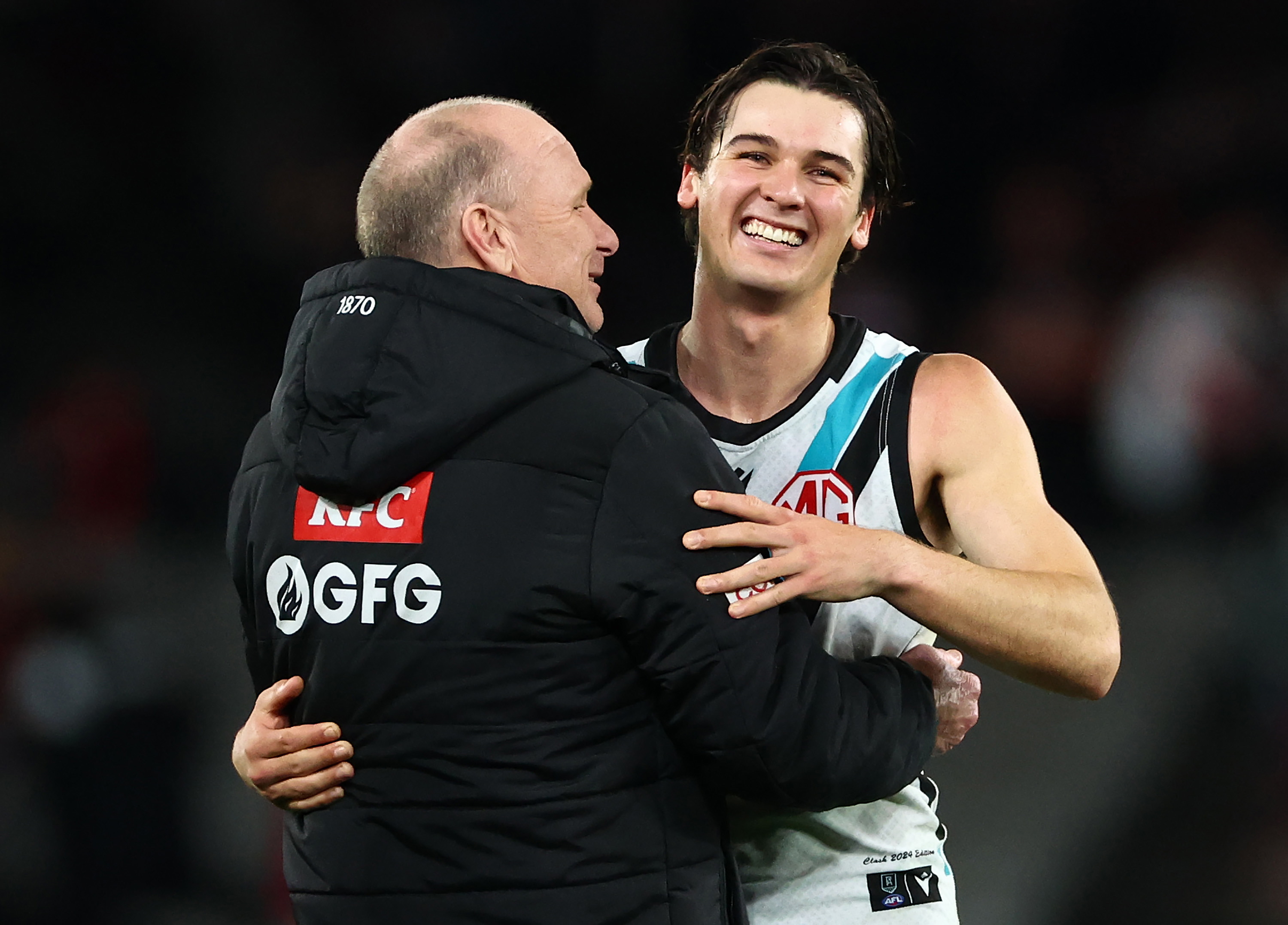 Ken Hinkley, Senior Coach of the Power and Connor Rozee celebrate their win over the Saints.