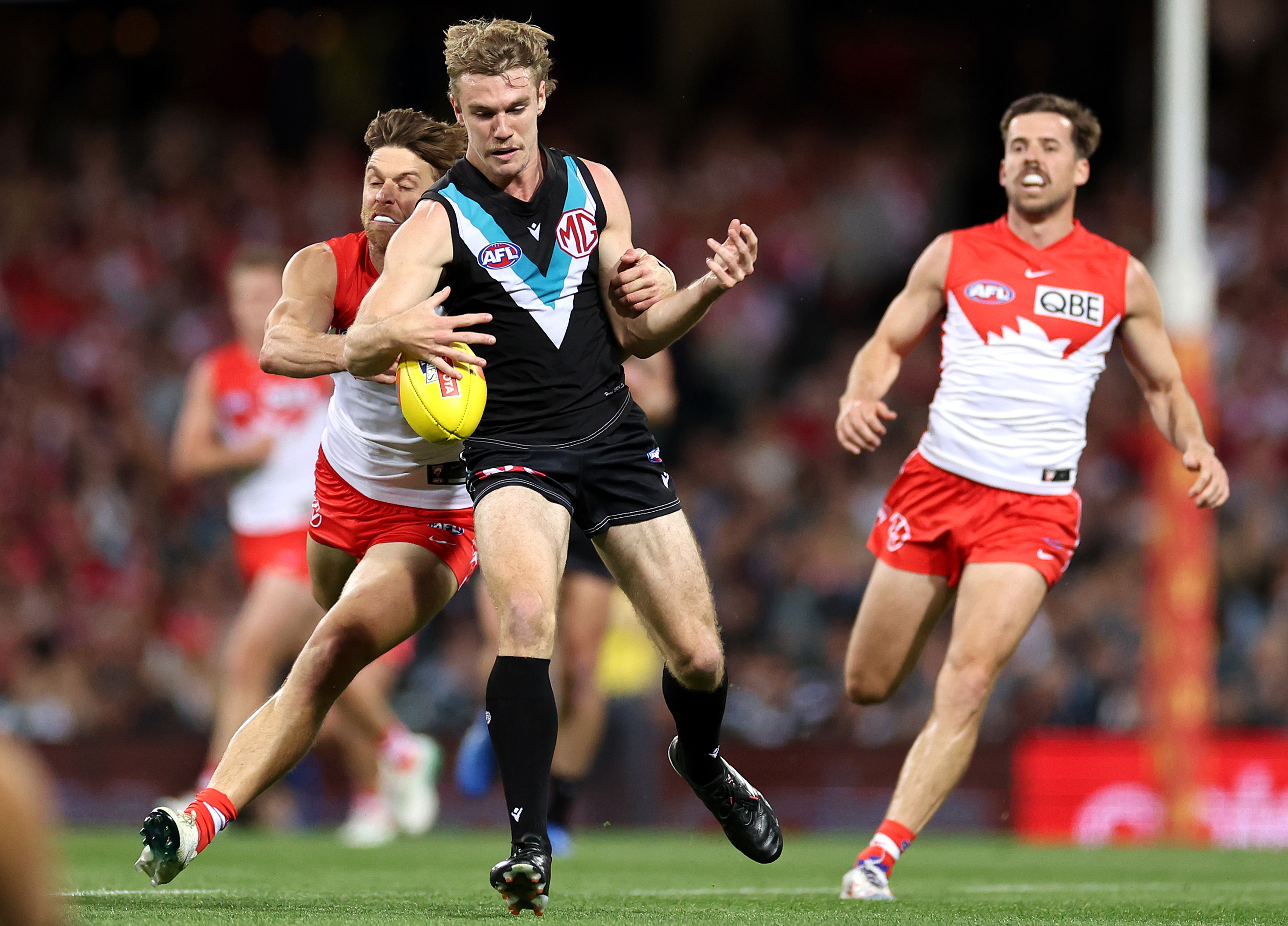 Jason Horne-Francis kicks whilst being tackled by Dane Rampe.