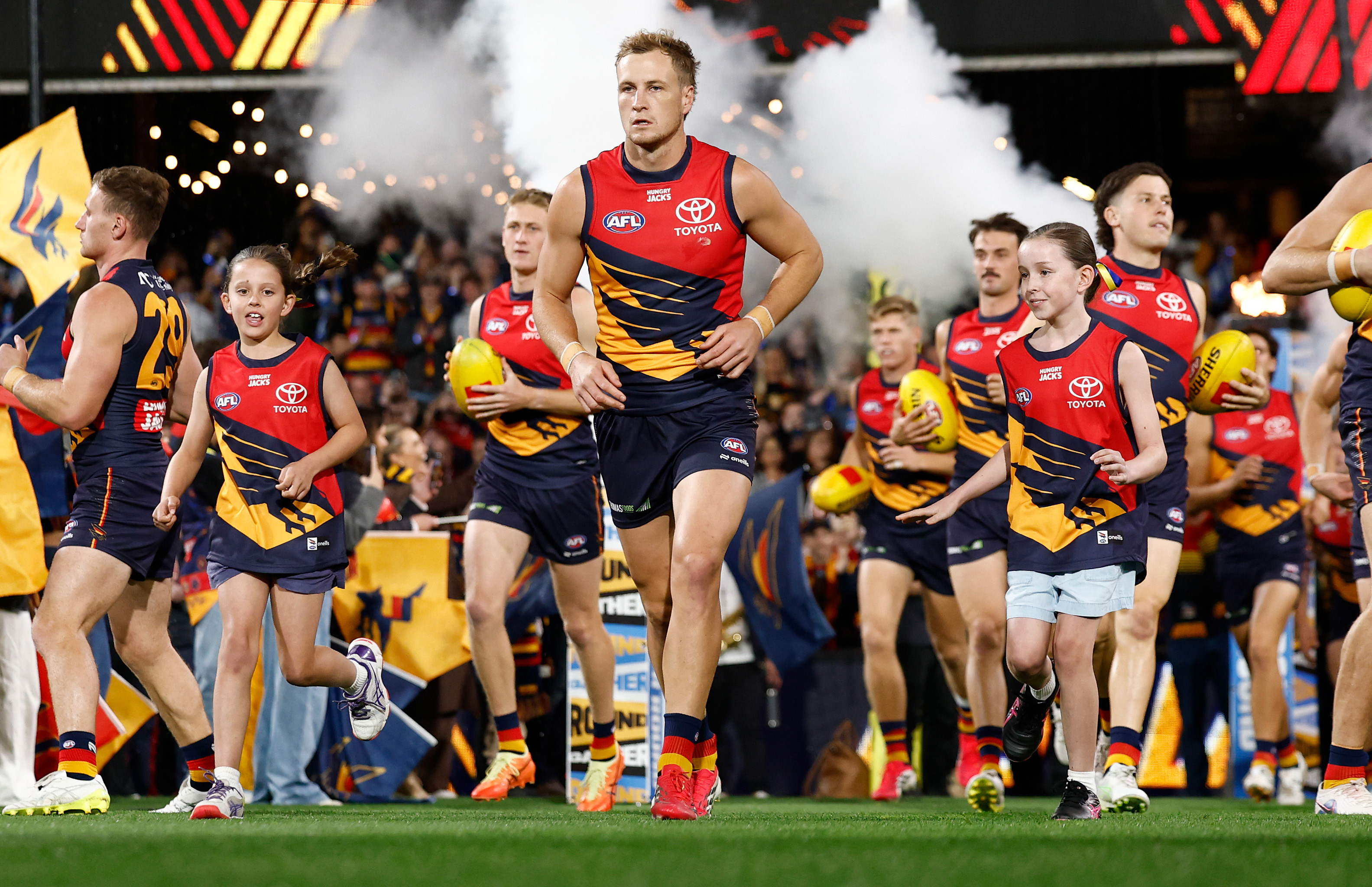 Jordan Dawson leads Adelaide onto the field.