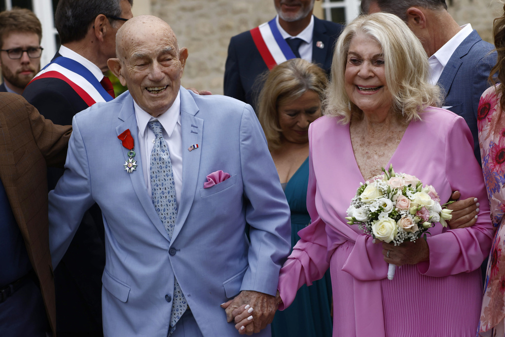 US WWII veteran Harold Terens, 100, left, and Jeanne Swerlin, 96, arrive to celebrate their wedding at the town hall of Carentan-les-Marais, in Normandy, northwestern France