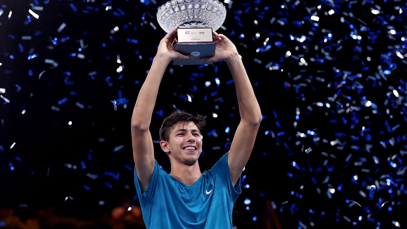 Alexei Popyrin of Australia holds the winner's trophy after his victory in Men's Singles Final match against Alexander Bublik of Kazakhstan on day seven of the Singapore Tennis Open 