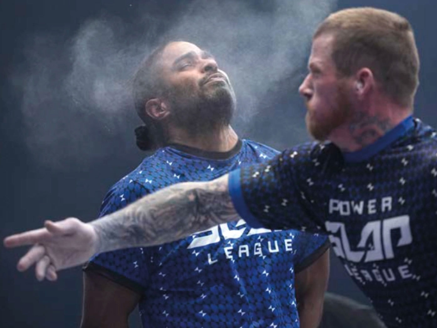 A contestant reels after being slapped in the face.