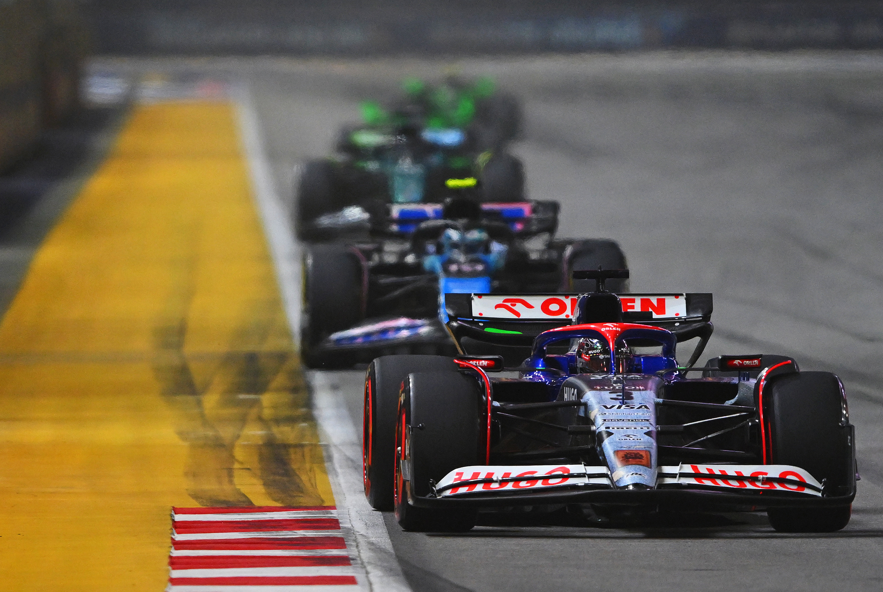 Daniel Ricciardo of Australia driving the (3) Visa Cash App RB VCARB 01 leads Pierre Gasly of France driving the (10) Alpine F1 A524 Renault on track during the F1 Grand Prix of Singapore at Marina Bay Street Circuit on September 22, 2024 in Singapore, Singapore. (Photo by Rudy Carezzevoli/Getty Images)