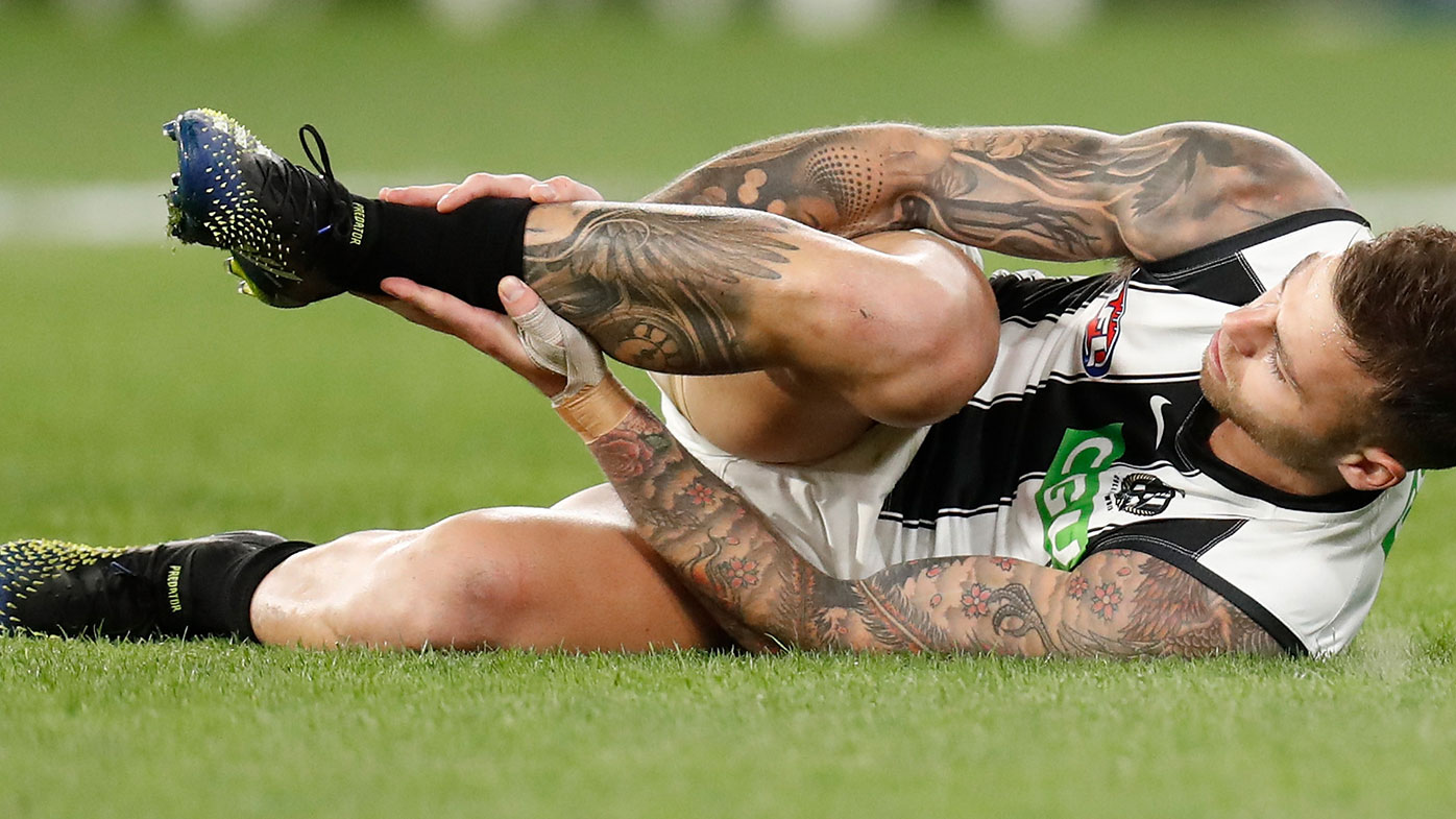 Jamie Elliott grabs his injured leg during Collingwood's Round Two win over Carlton at the MCG.