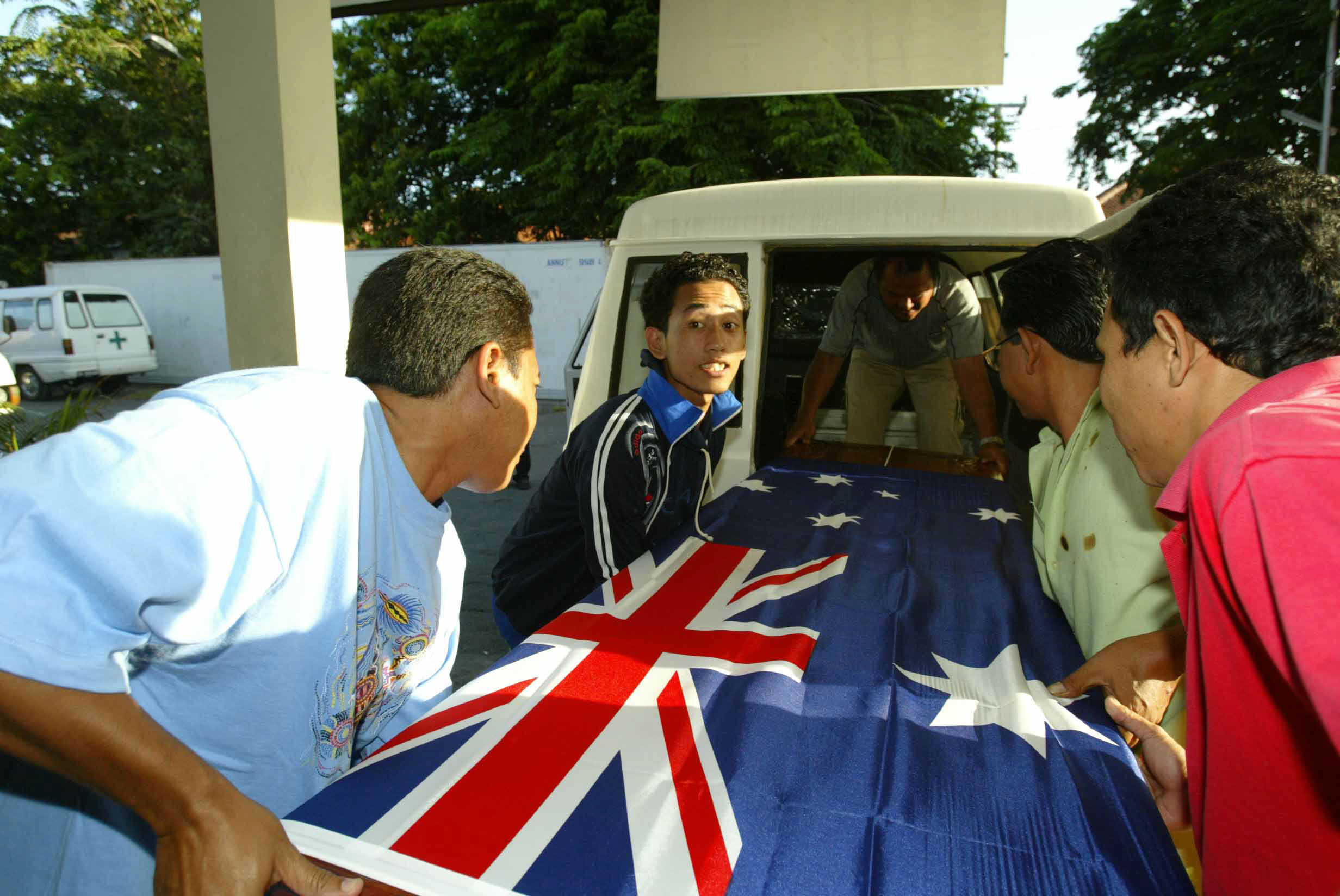 Three coffins containing Australian victims of the 2005 Bali bombings, draped in an Australian flag.