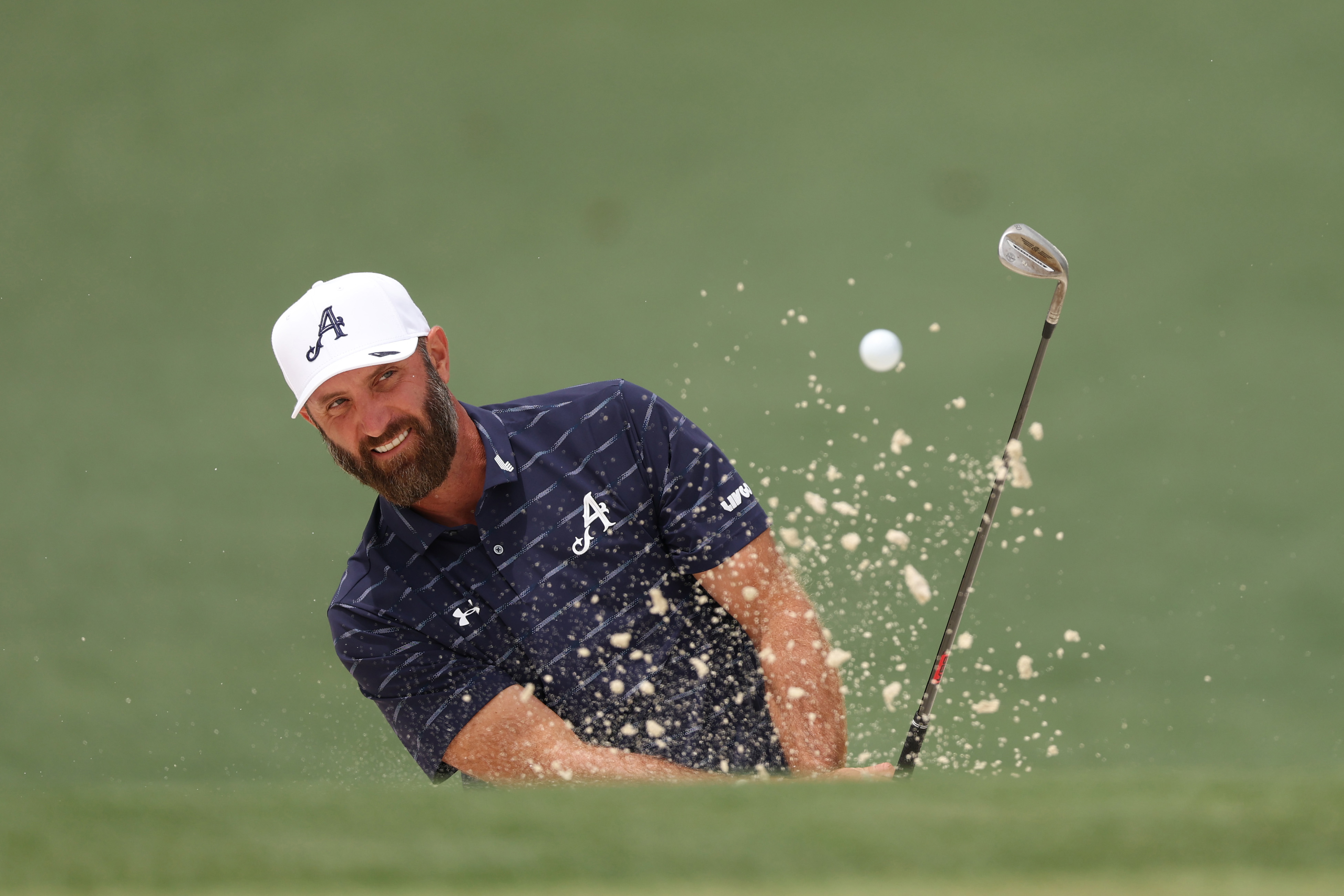 Dustin Johnson of the United States hits out of a greenside bunker during a practice round prior to the 2026 Masters Tournament at Augusta National Golf Club on April 06, 2026 in Augusta, Georgia. (Photo by Andrew Redington/Getty Images)