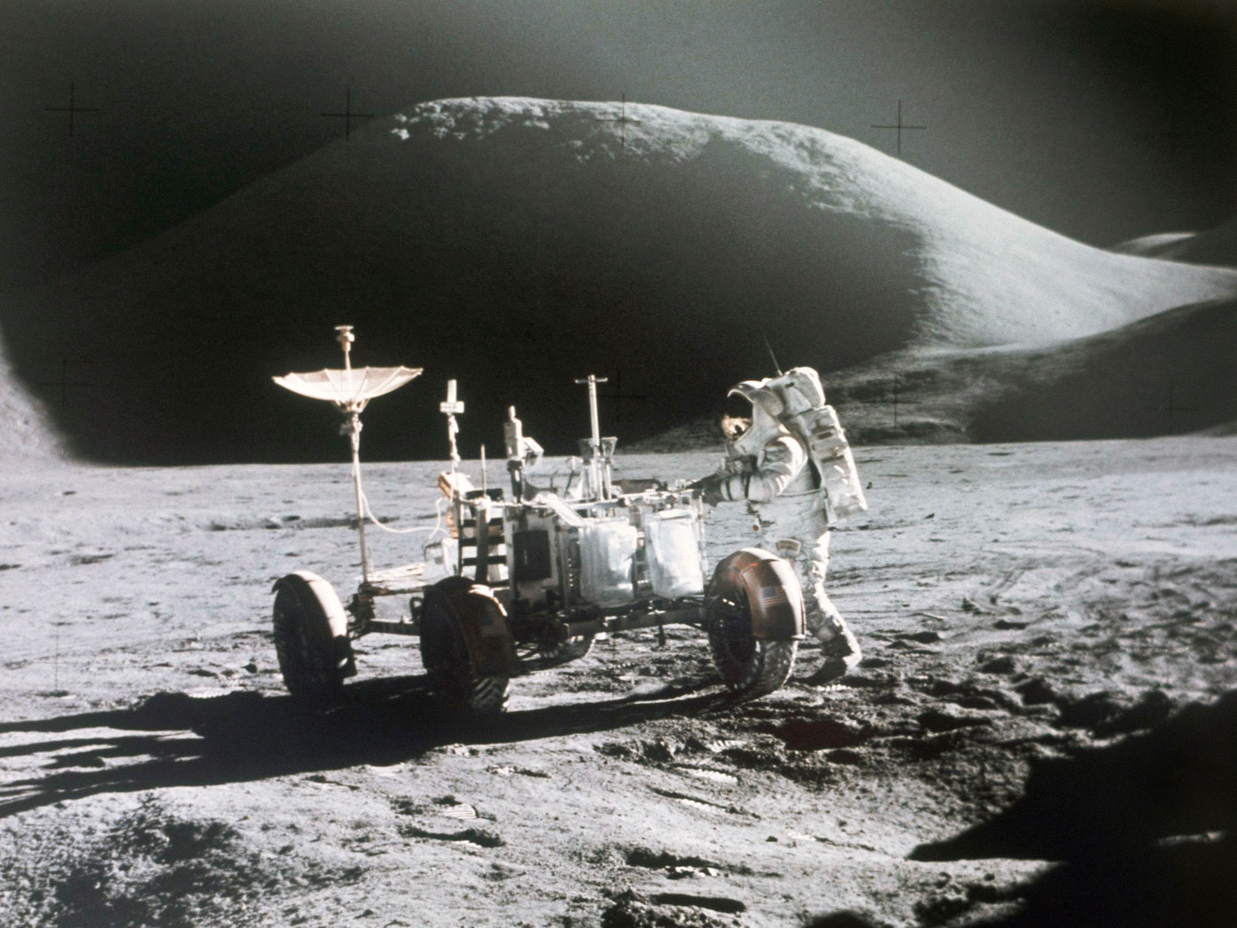 NASA astronaut James Irwin stands next to a rover on the surface of the moon in 1971.
