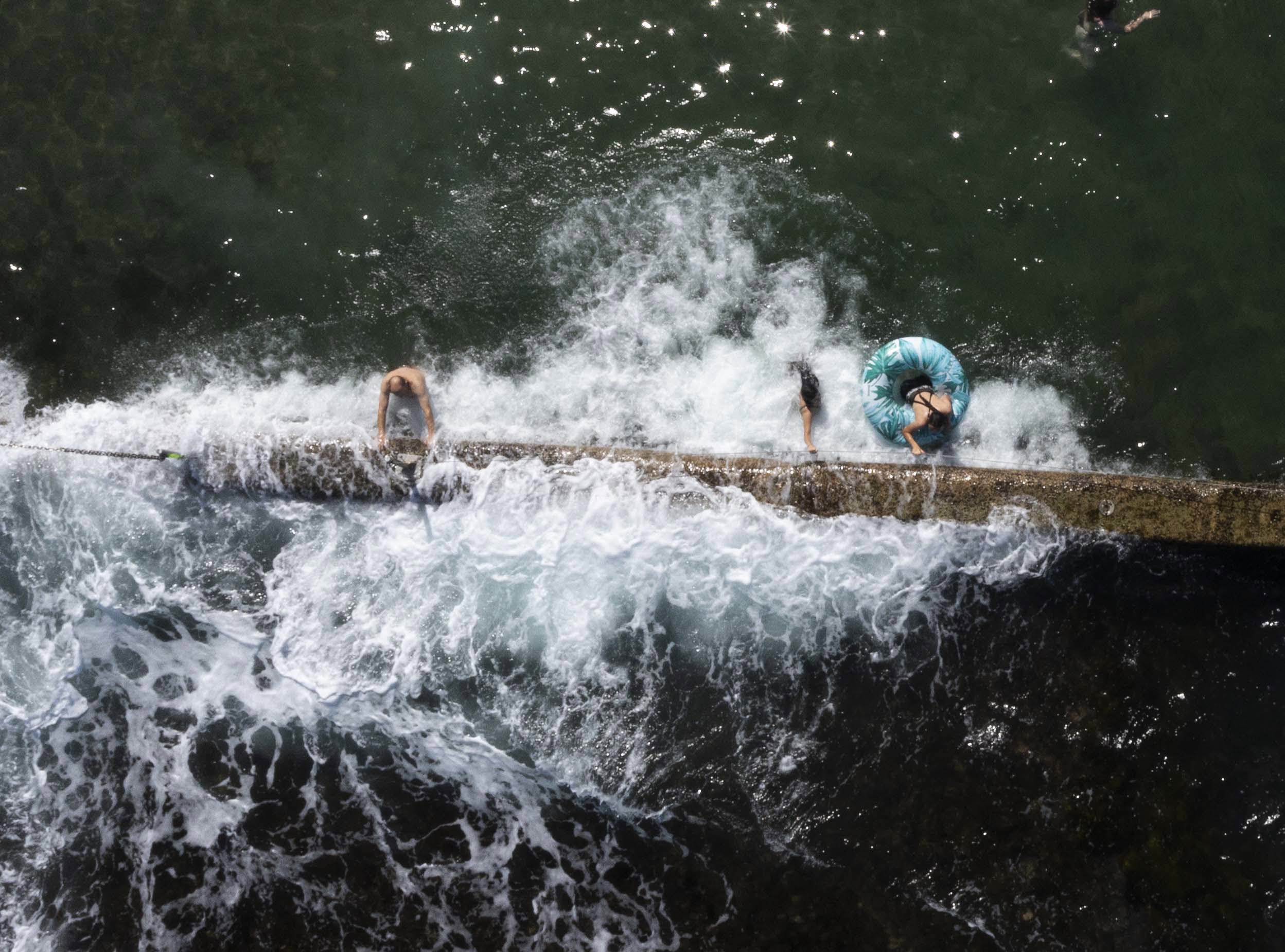 Swimmers cool off in Oak Park Rock Pool in Sydney on a scorching summer's day