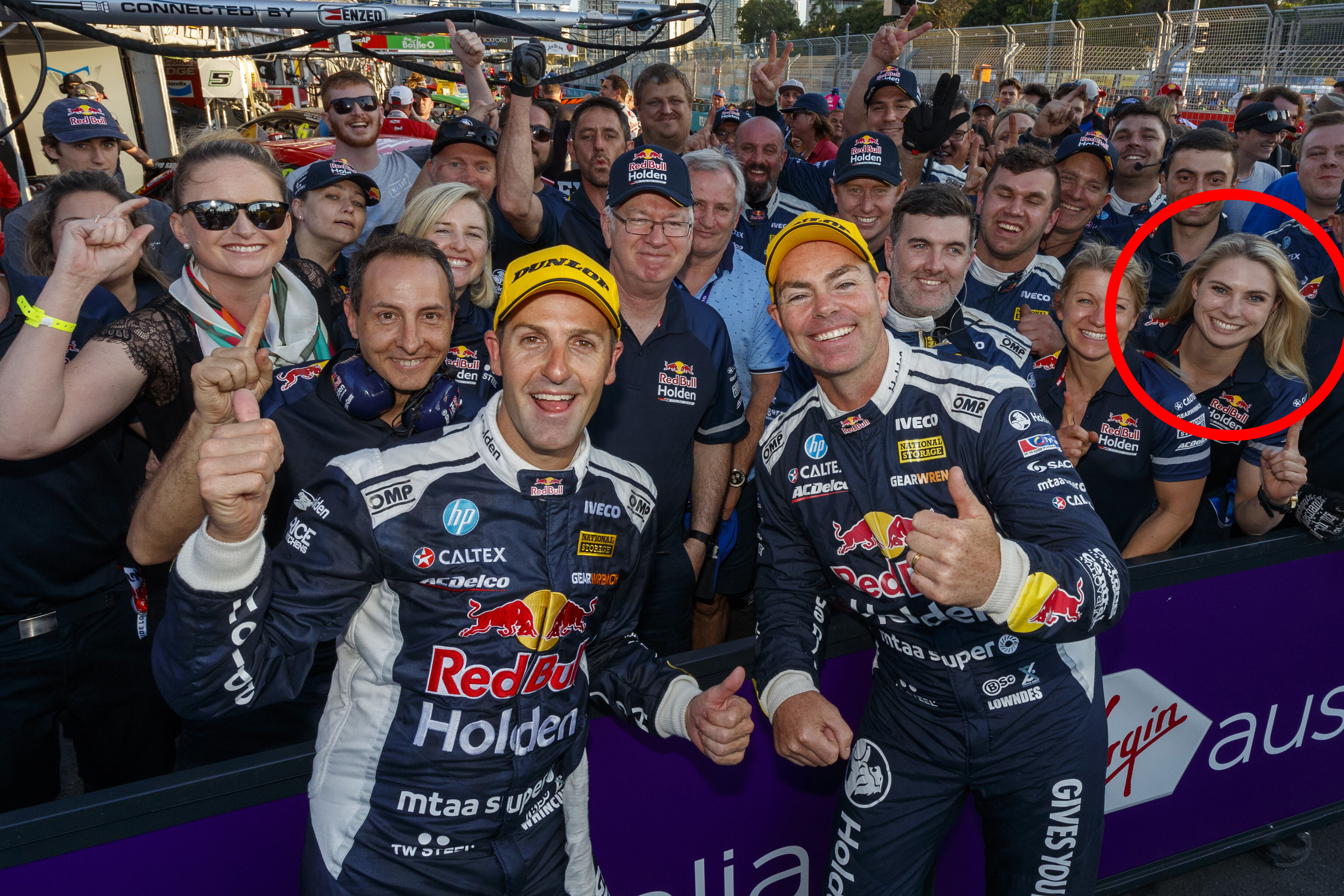 Jamie Whincup and Craig Lowndes celebrate victory at the Gold Coast 600 with Triple Eight Race Engineering team members including Jessica Dane (circled).