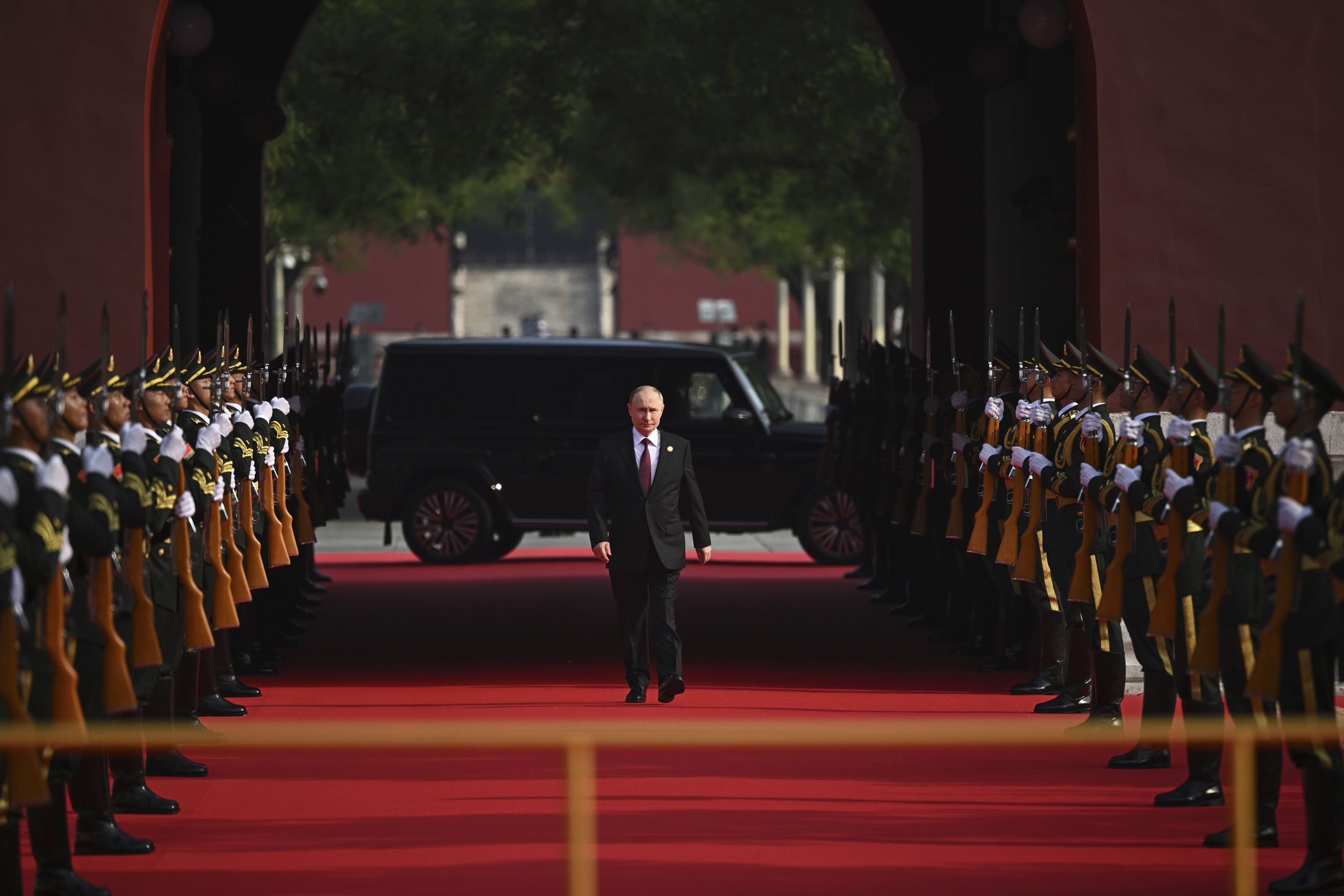 Putin walks to attend a joint photo session of the heads of foreign delegations invited to the military parade.