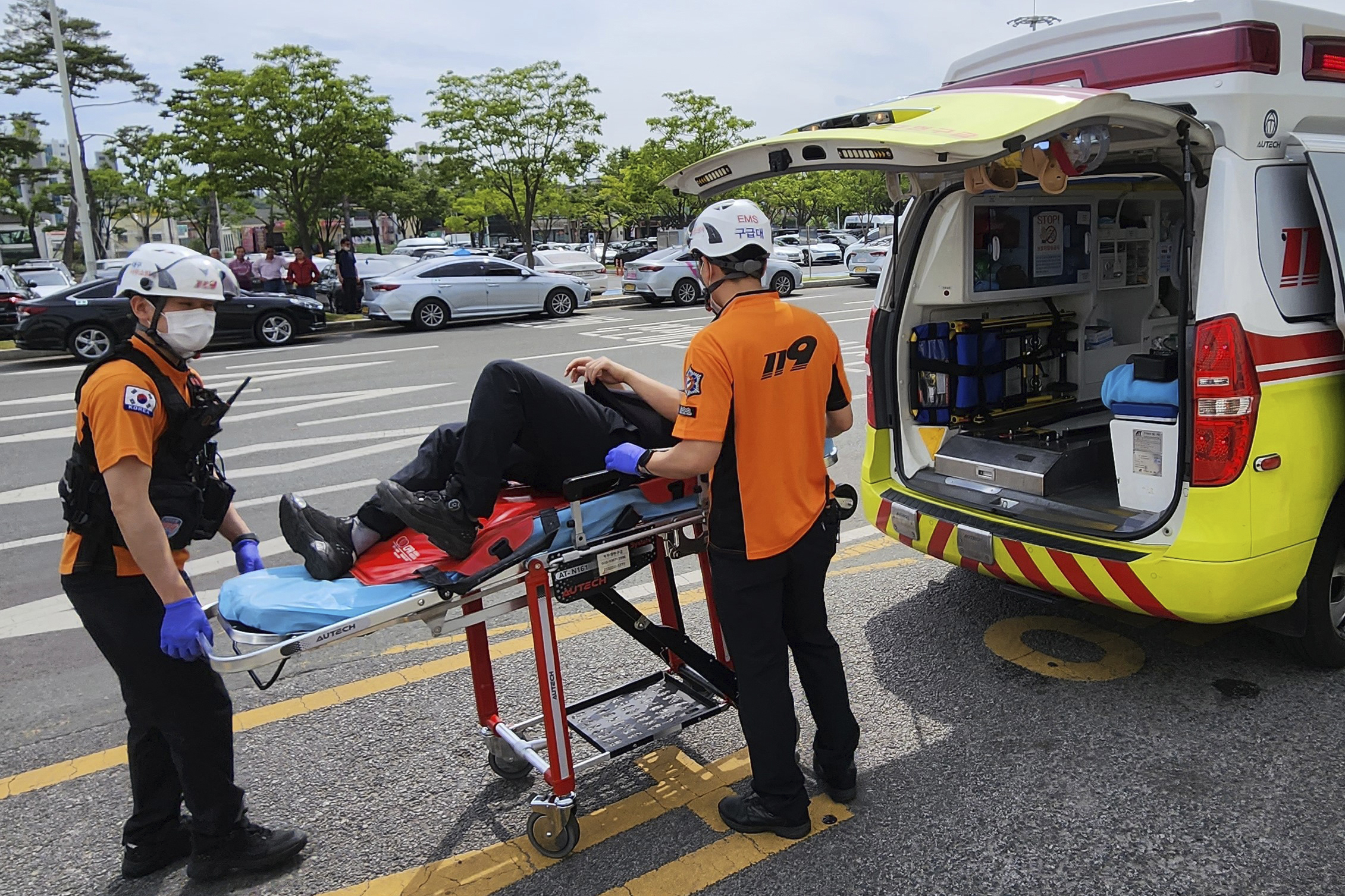 Rescue workers move a passenger on a stretcher to an ambulance at Daegu International Airport in Daegu, South Korea, Friday, May 26, 2023. 