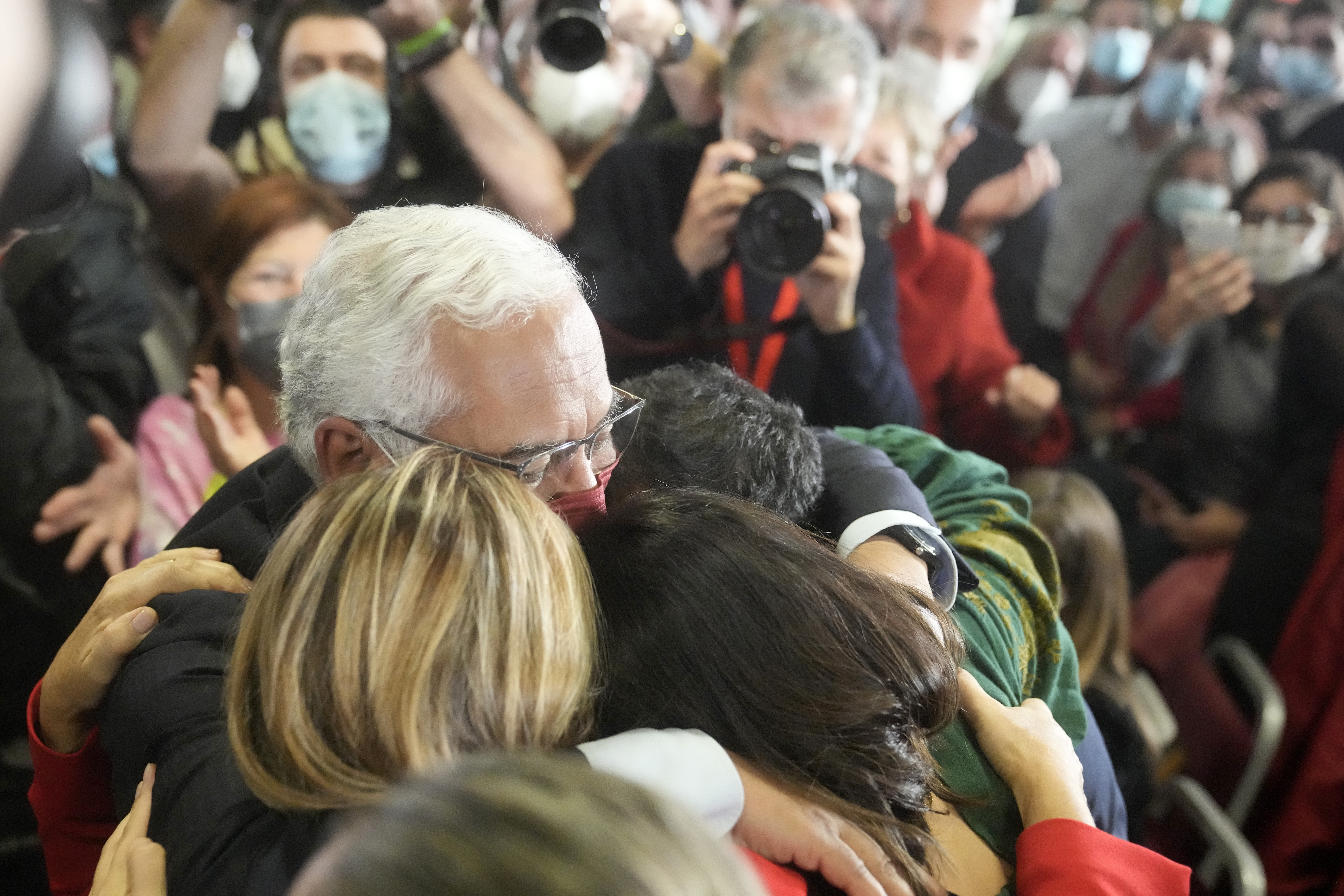 Portuguese Prime Minister and Socialist Party Secretary General Antonio Costa hugs his wife, daughter and son after delivering a speech following election results in which Portugal's center-left Socialist Party won a third straight general election, returning it to power, Lisbon, Monday, Jan. 31, 2022. 