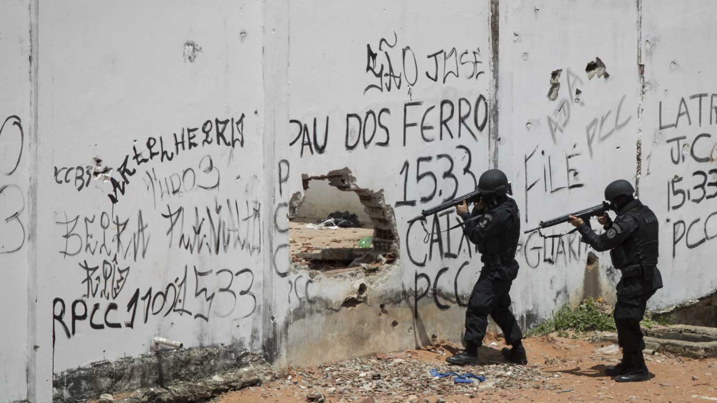 Police enter a jail during a prisoner revolt in Natal, Brazil.