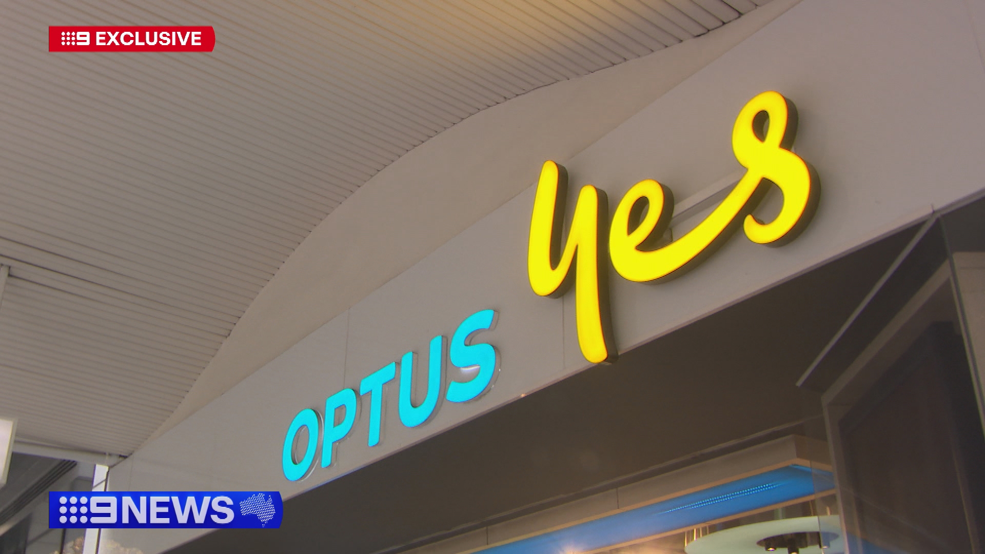 A low angle shot of the front of an Optus store sign.