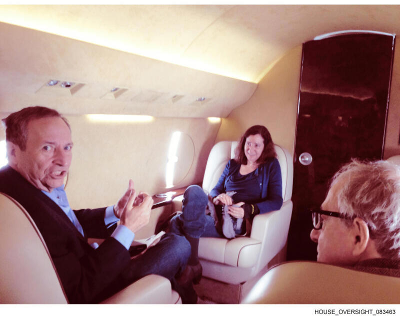This undated photo released by Democrats on the House Oversight Committee shows Larry Summers, left, his wife, Elisa New, centre, and Woody Allen on an plane.